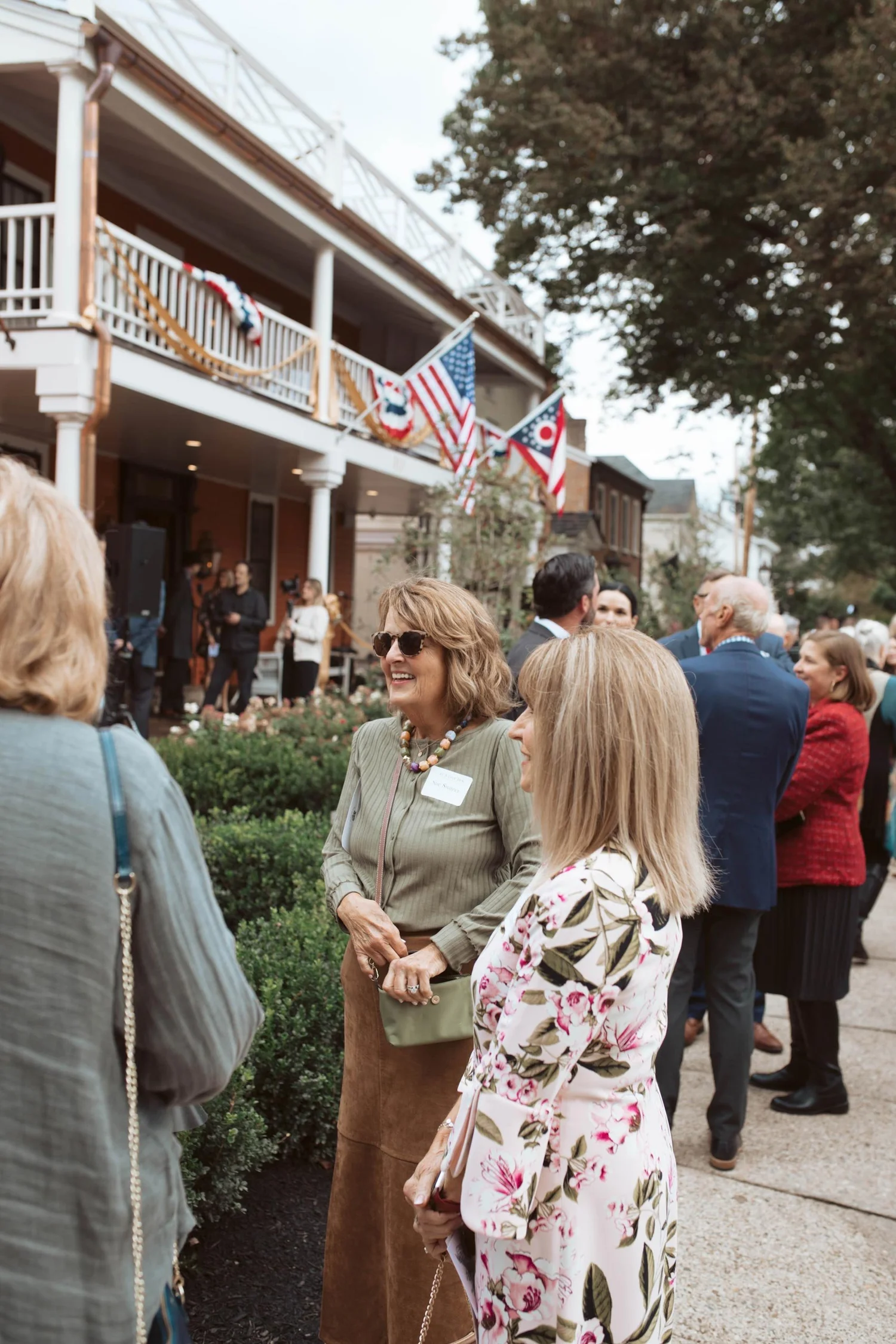 Guests enjoying a conversation on the front lawn.