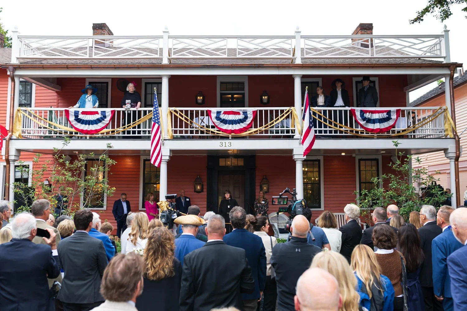 The crowd facing the decorated Buxton Inn during the ceremony.
