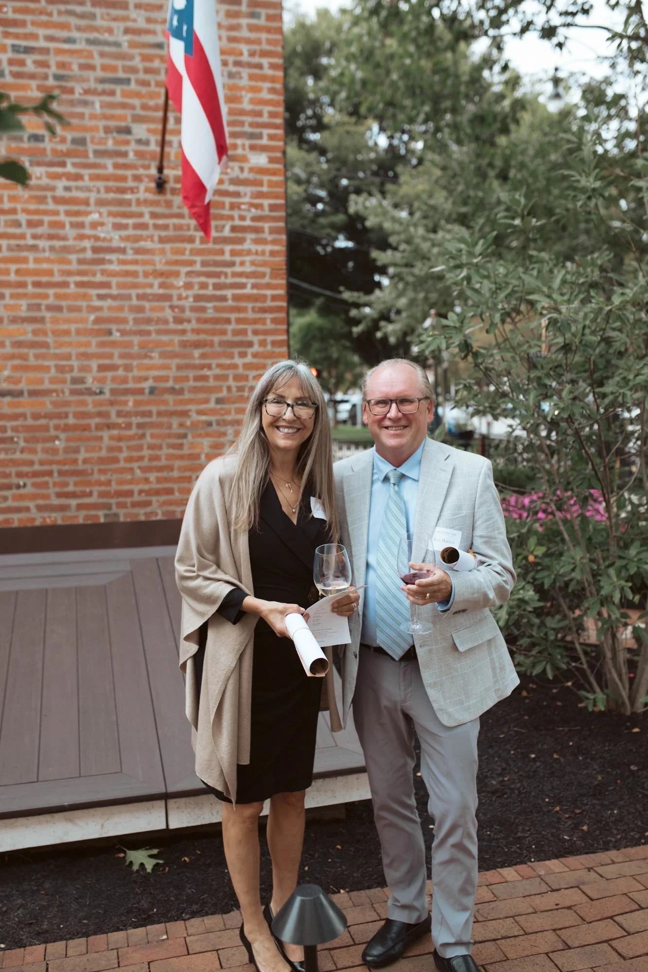 Two guests posing together beside the inn.