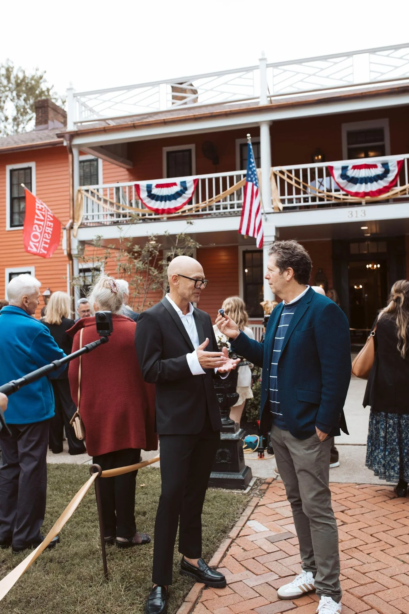 An interview taking place on the lawn outside the inn.