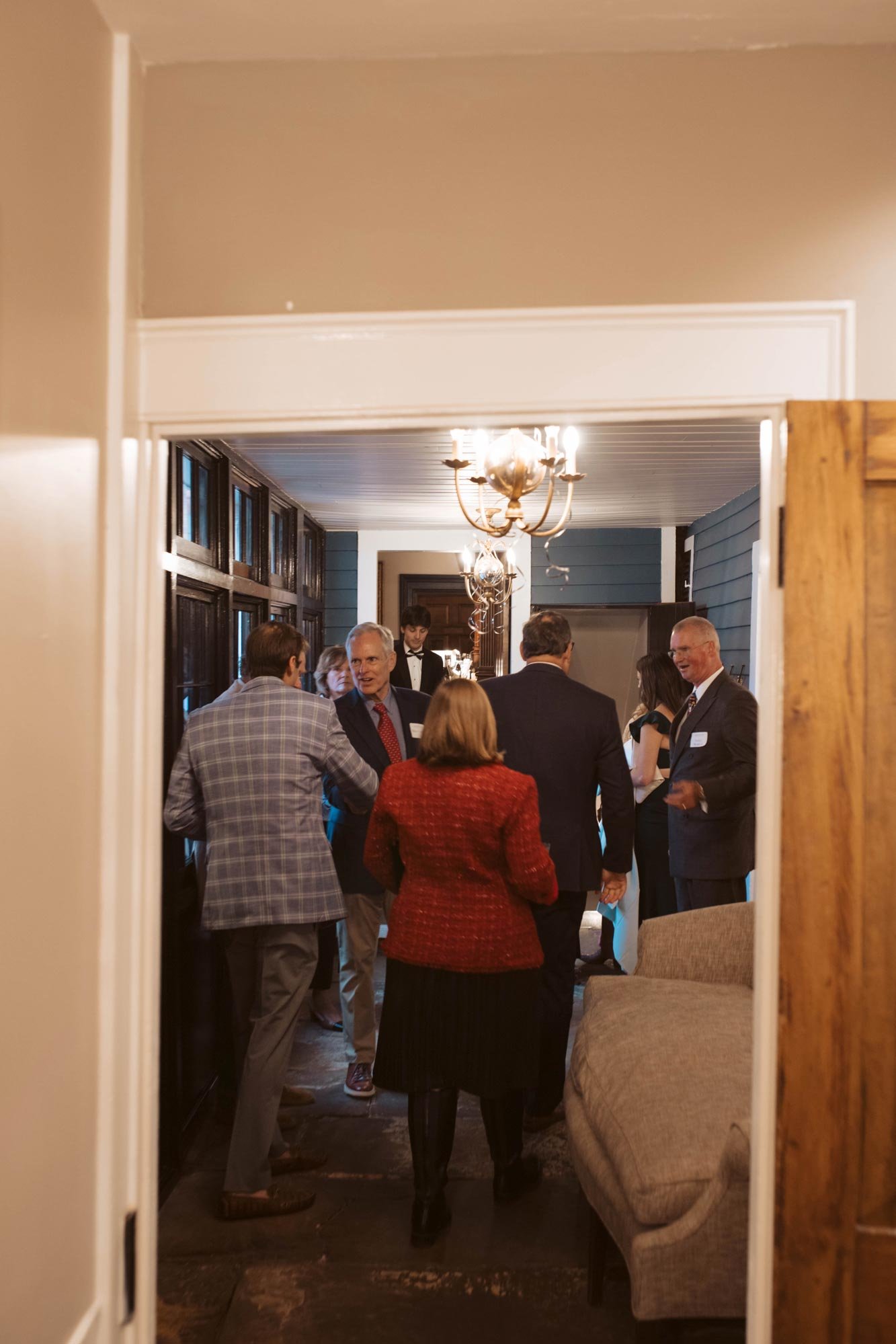 Guests socializing in the main building's hallway.