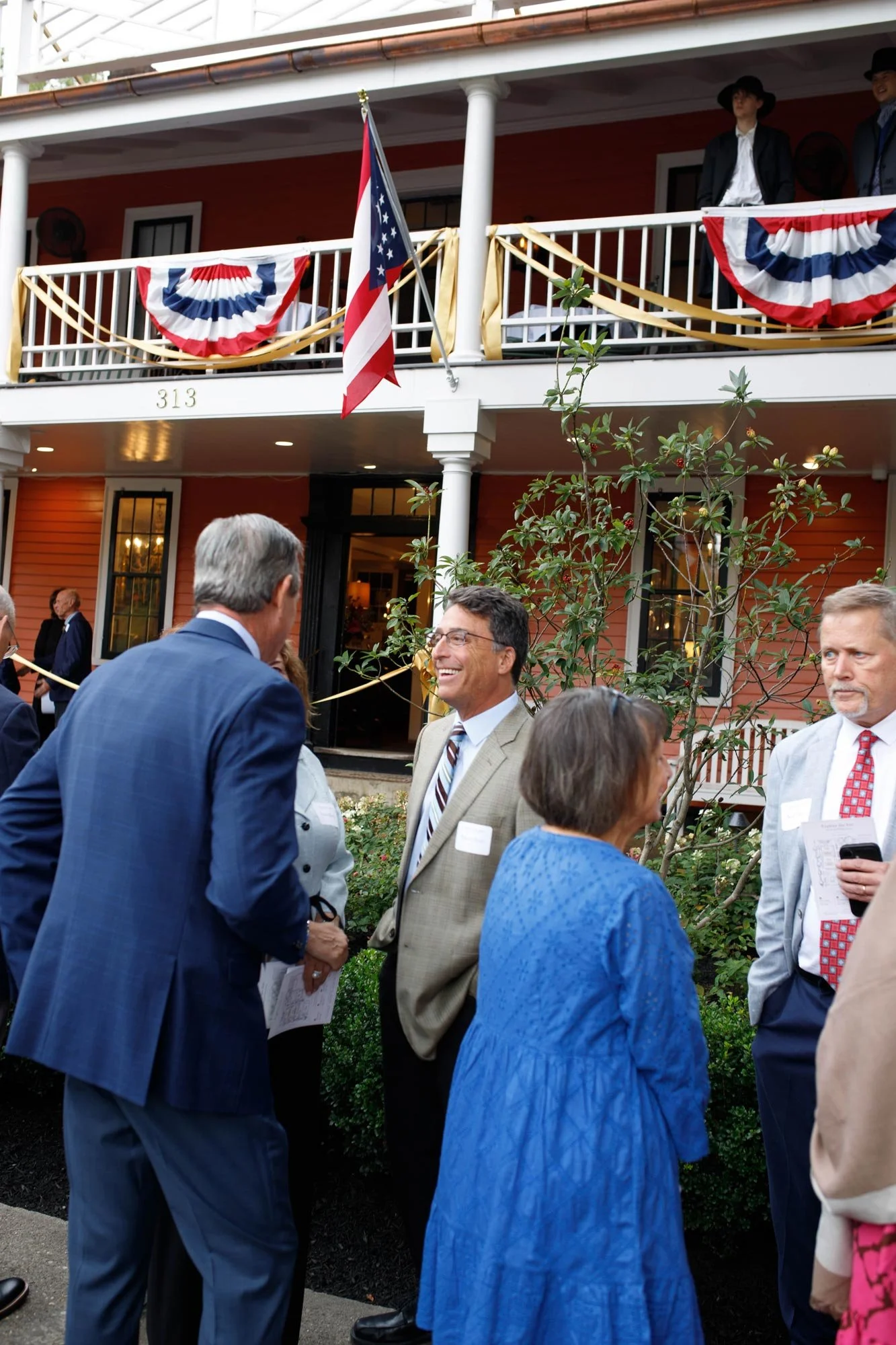 Guests greeting one another outside the inn.