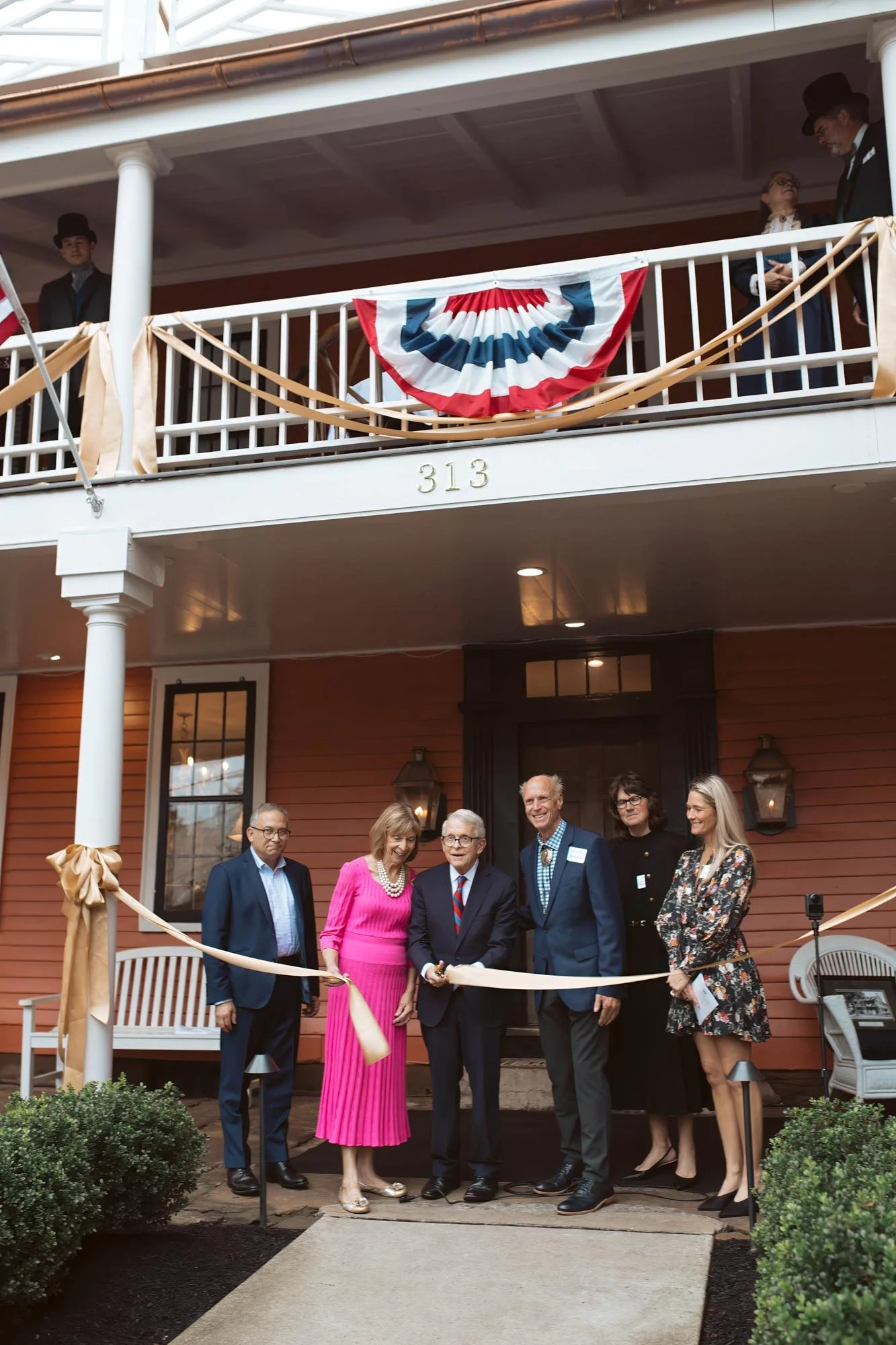 The ceremonial ribbon being cut in front of The Buxton Inn.