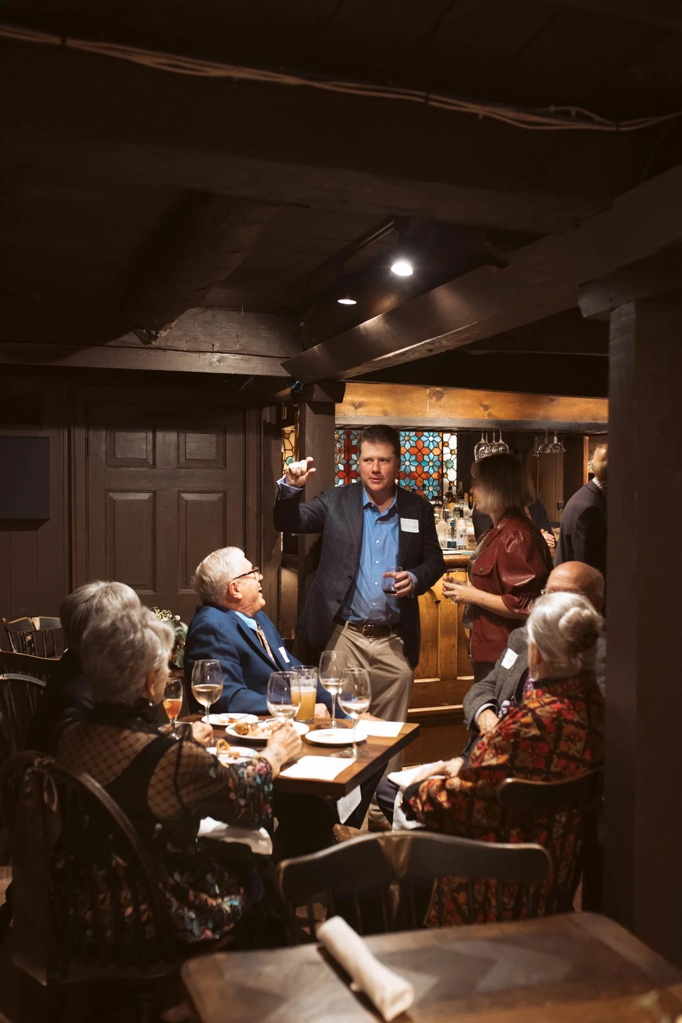 Guests gathered around a table in the tavern.