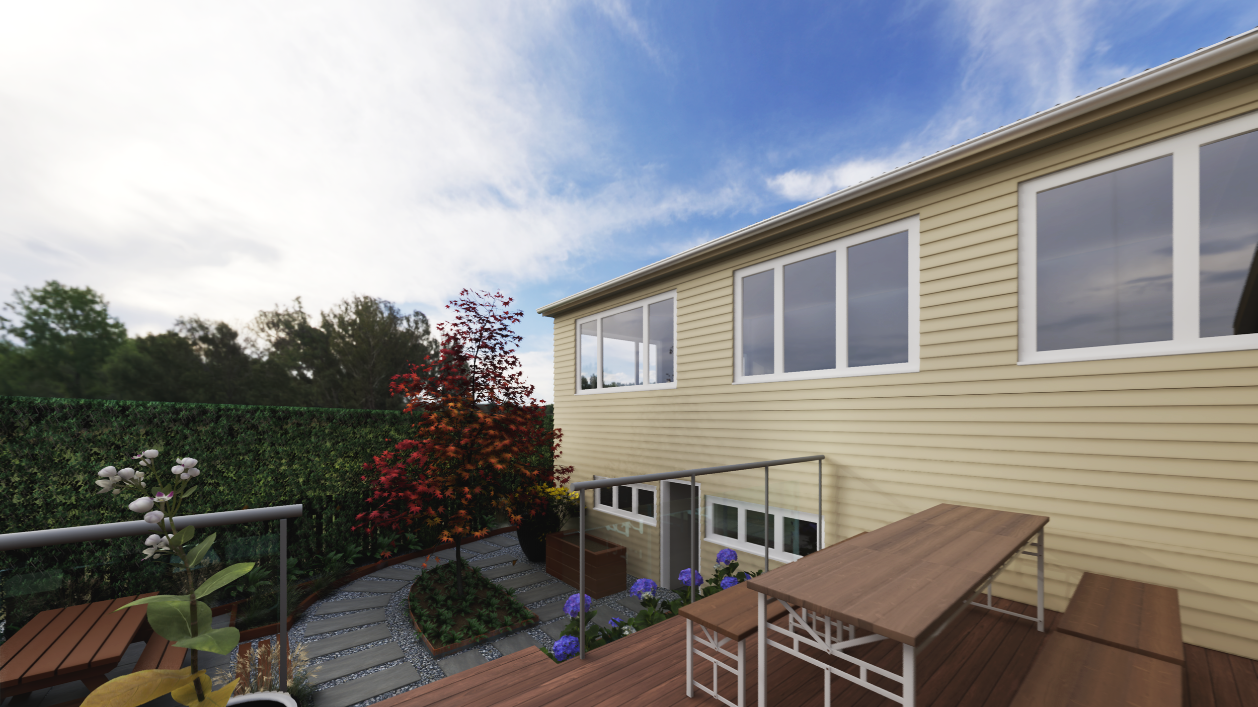 A backyard patio with wooden furniture, potted plants, flowers, a green hedge, and a yellow house with large windows under a blue sky with clouds.