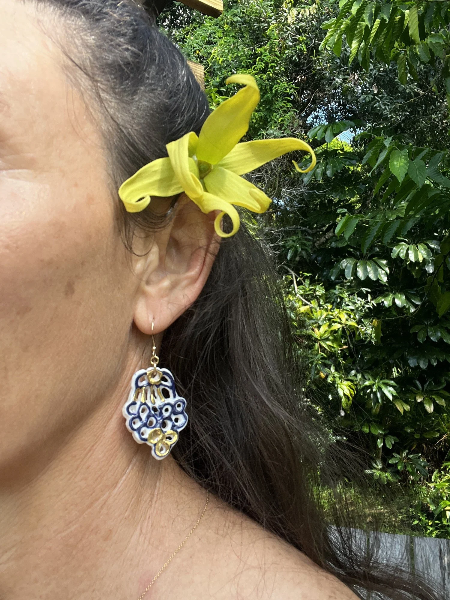 Porcelain earring No. 008 in cobalt blue and gold luster worn on the ear