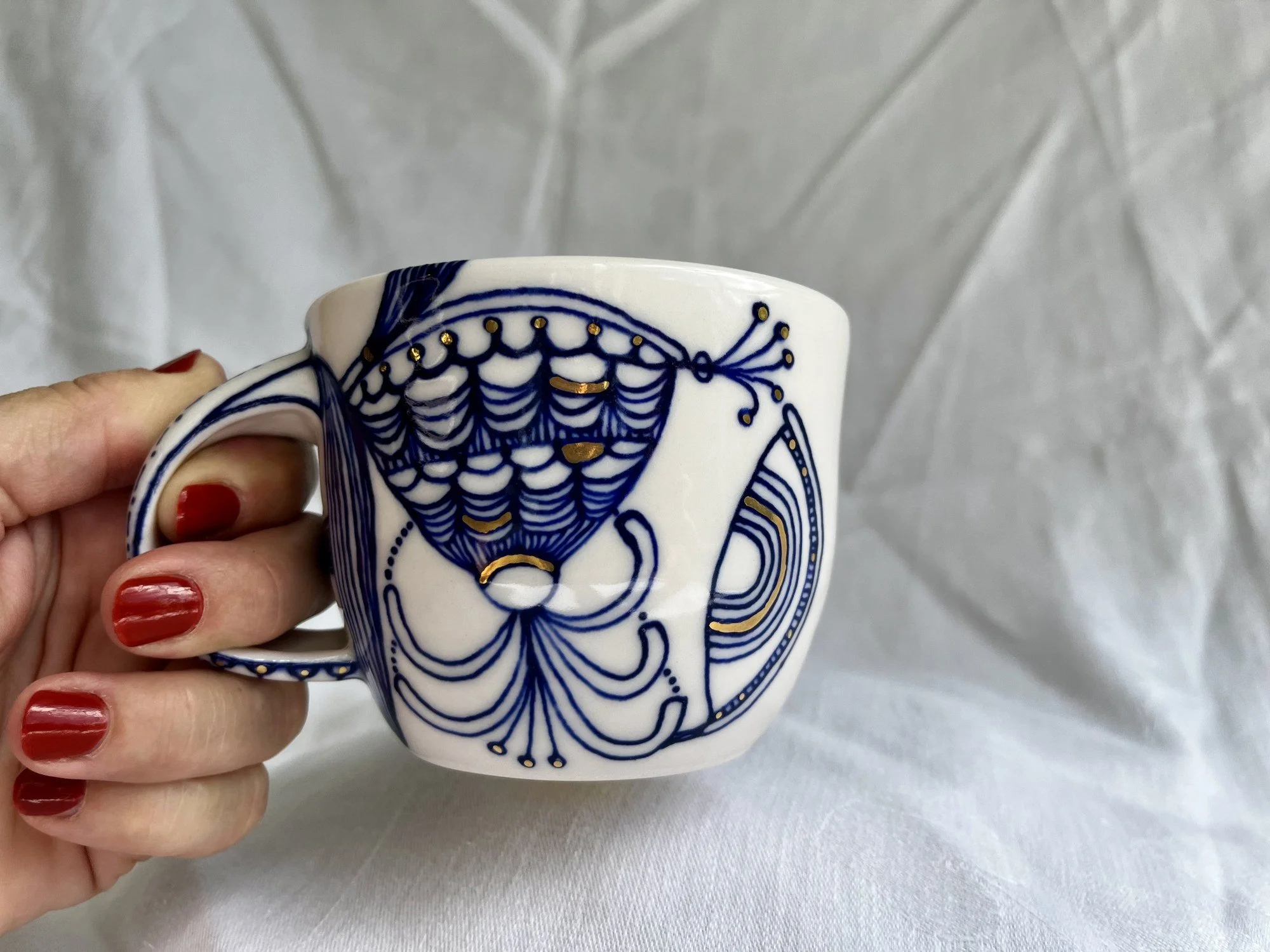 Porcelain mug No. 029 held in hand to show its size