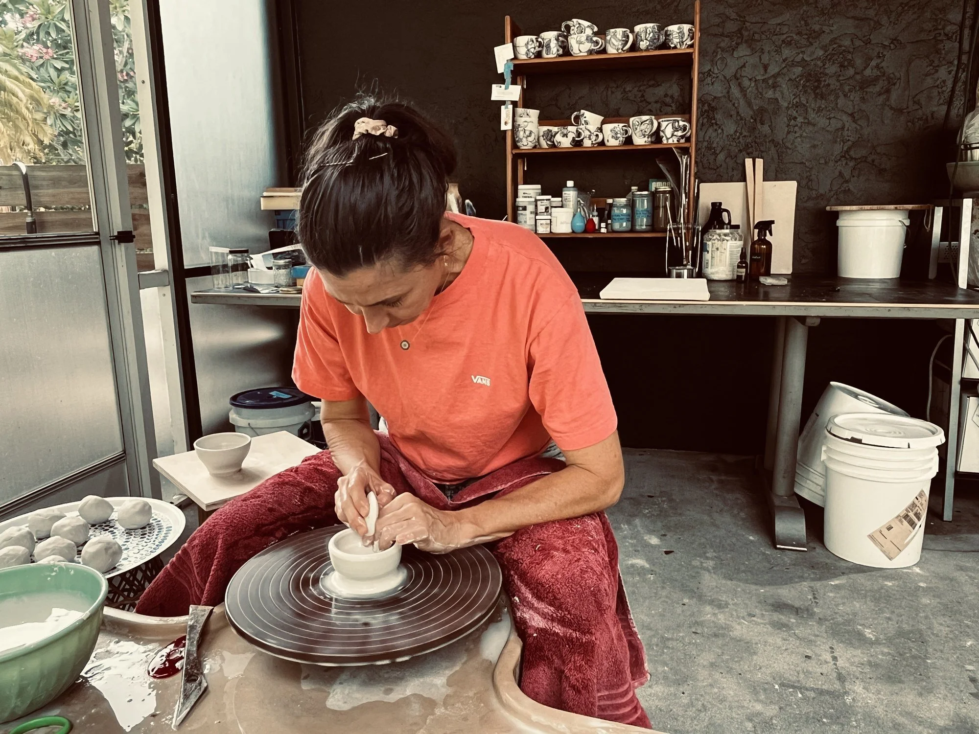 Lana throwing a pot on the wheel in the Cypress Knees Ceramics studio in Naples, Florida