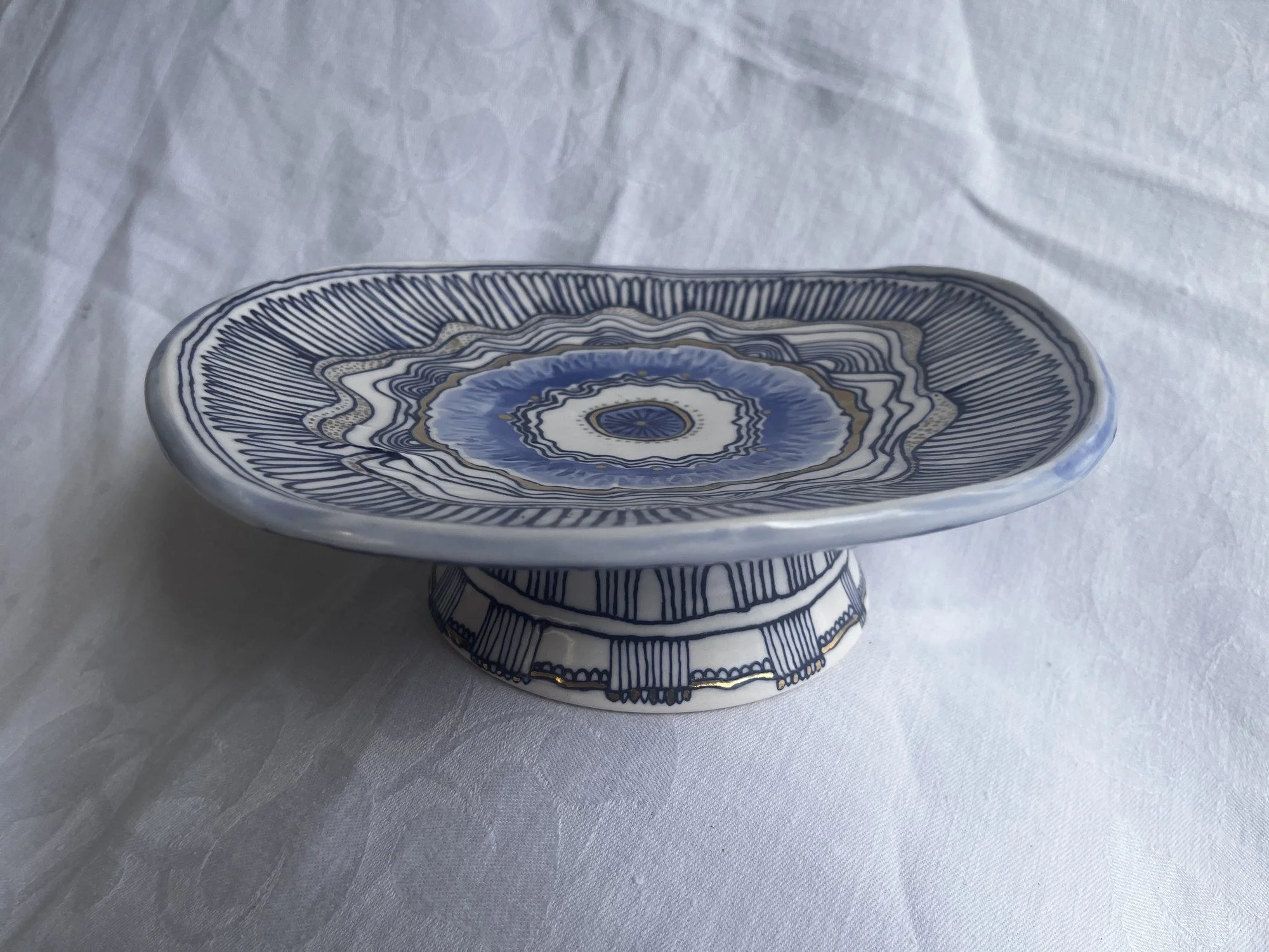 Hand-thrown porcelain footed serving dish in cobalt blue and gold luster by Cypress Knees Ceramics
