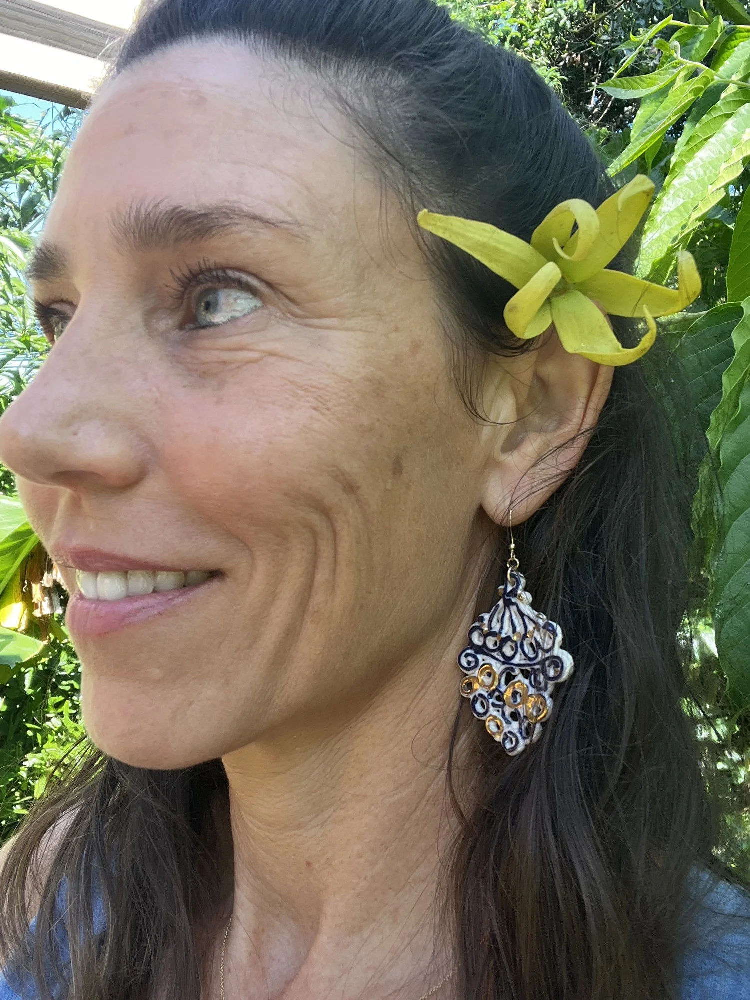 Hand-painted cobalt blue and gold luster porcelain earring No. 001 worn on the ear