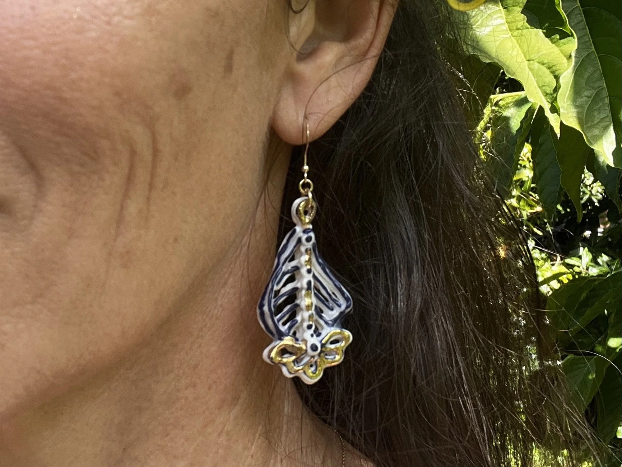 Porcelain earring No. 002 in cobalt blue and gold luster worn on the ear