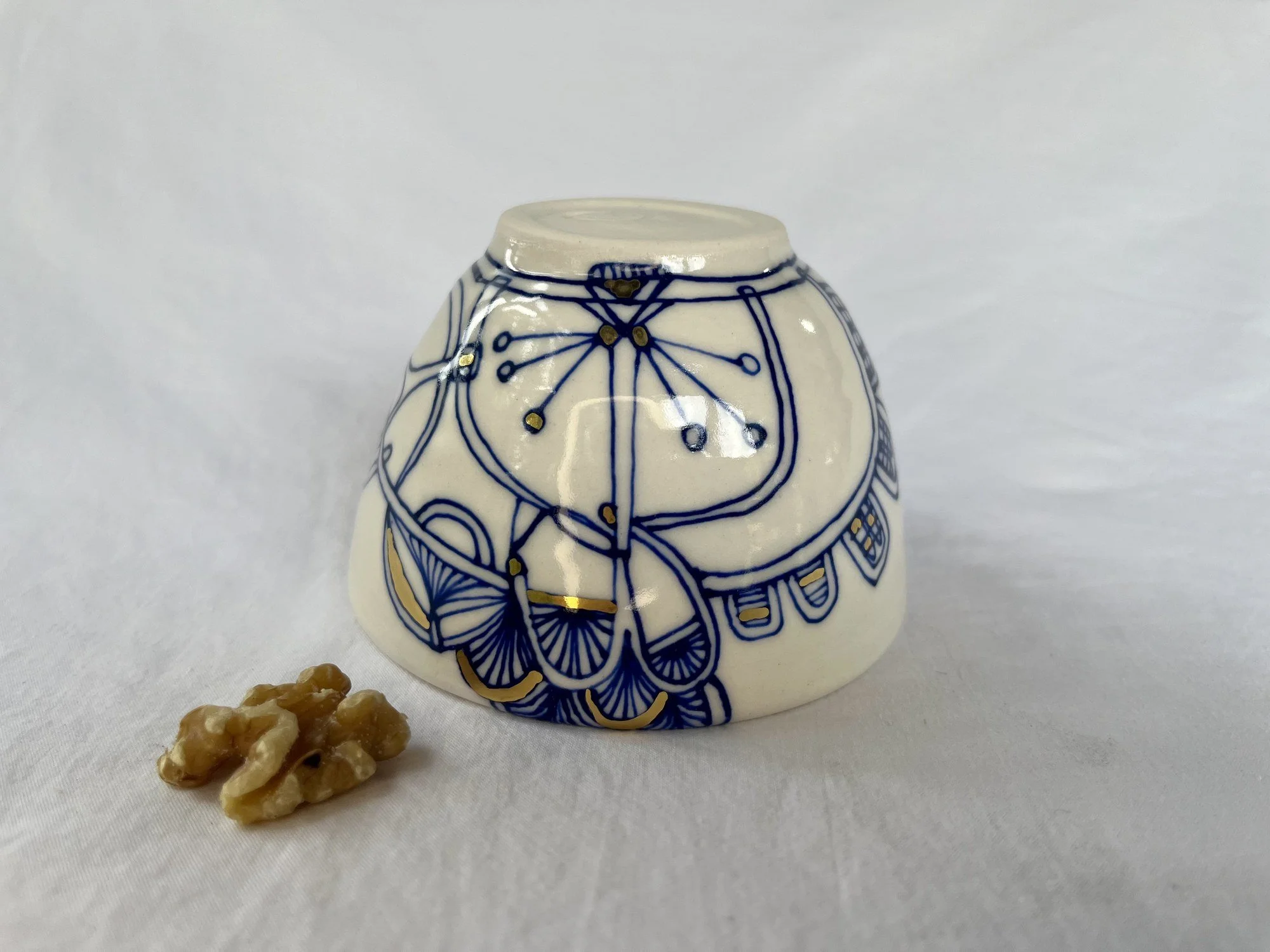 Close view of the cobalt and gold luster pattern on porcelain bowl No. 001