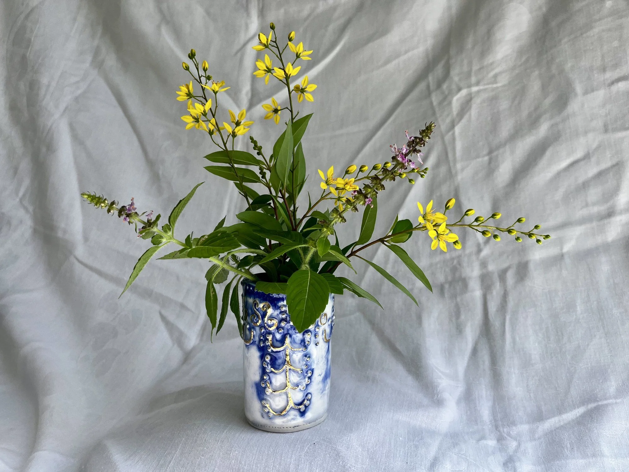 Hand-built porcelain bud vase No. 003 holding fresh flowers