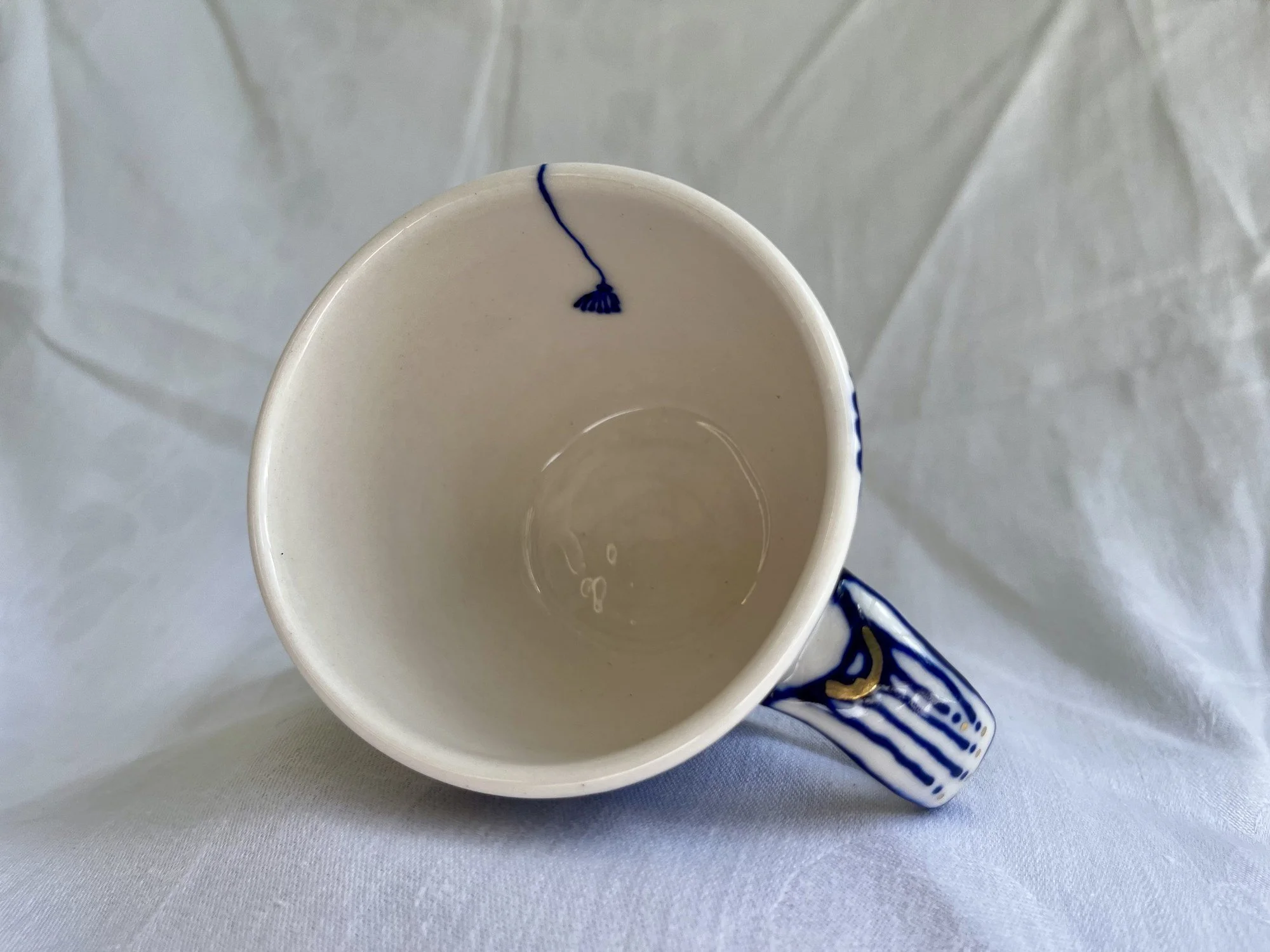 Interior of wheel-thrown porcelain mug No. 031, hand-painted in Naples, Florida