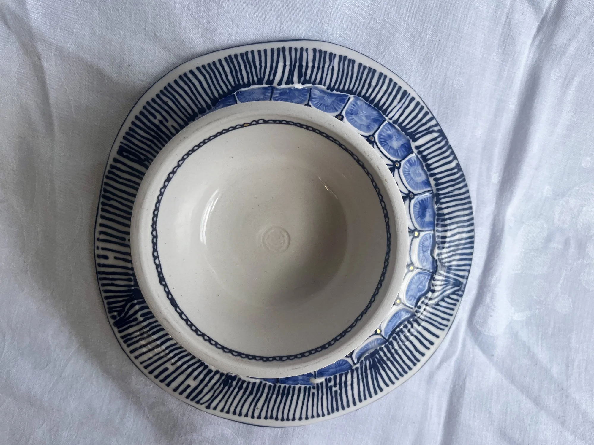 Underside of hand-thrown porcelain serving dish No. 001, made in Naples, Florida