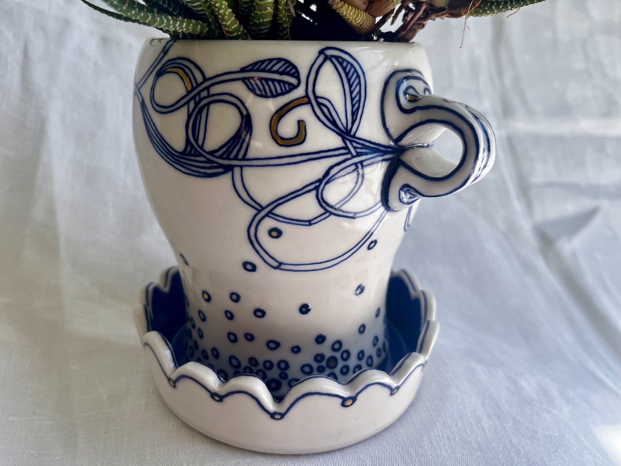 Close view of the cobalt and gold luster pattern on porcelain planter No. 001