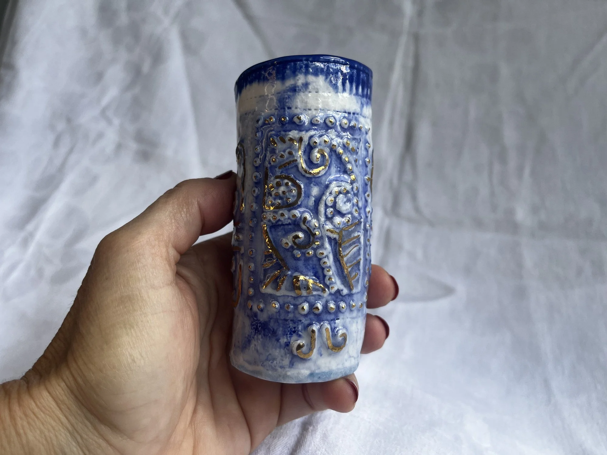 Small porcelain bud vase No. 002 held in hand to show its size