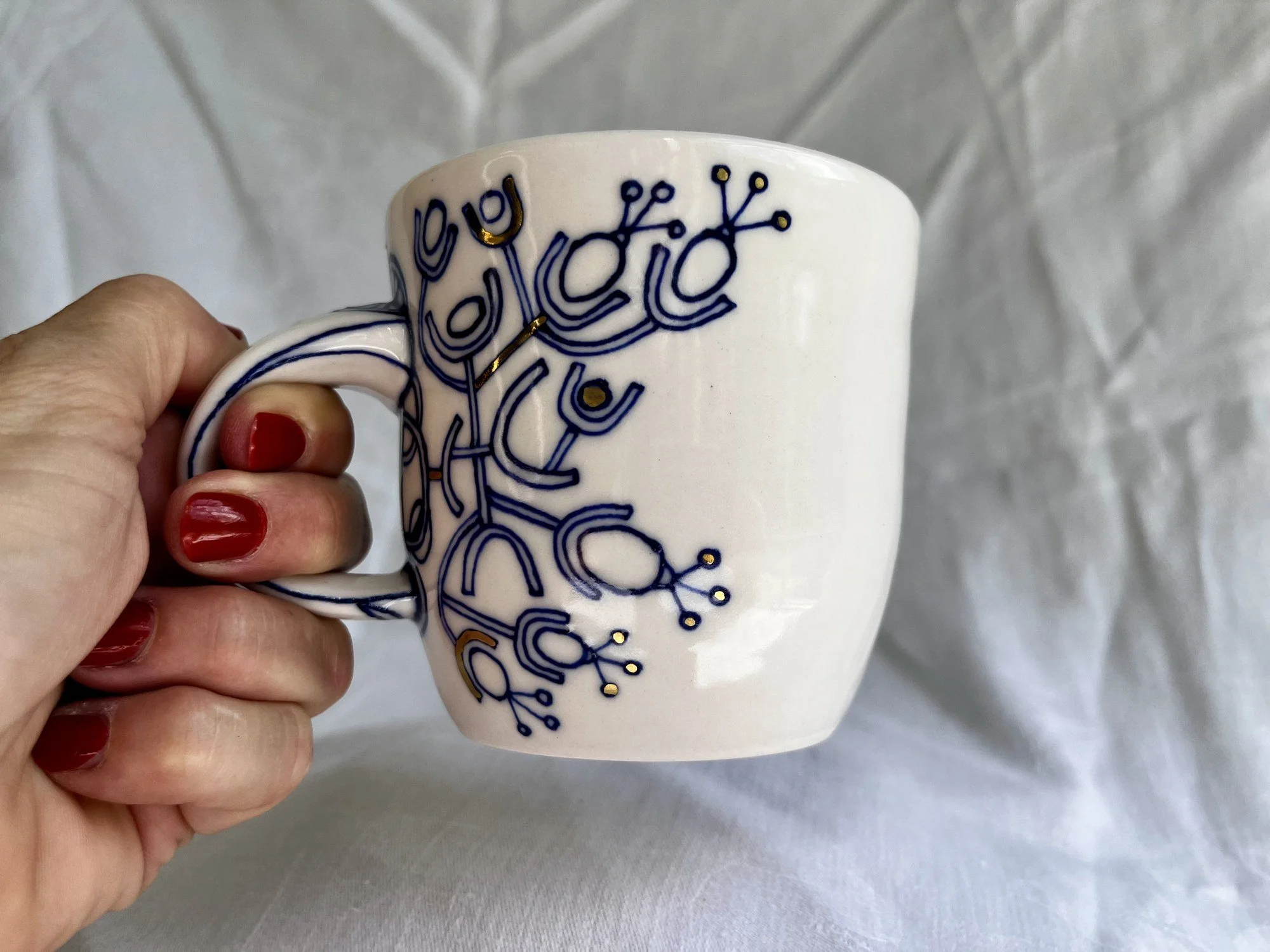 Porcelain mug No. 030 held in hand to show its size