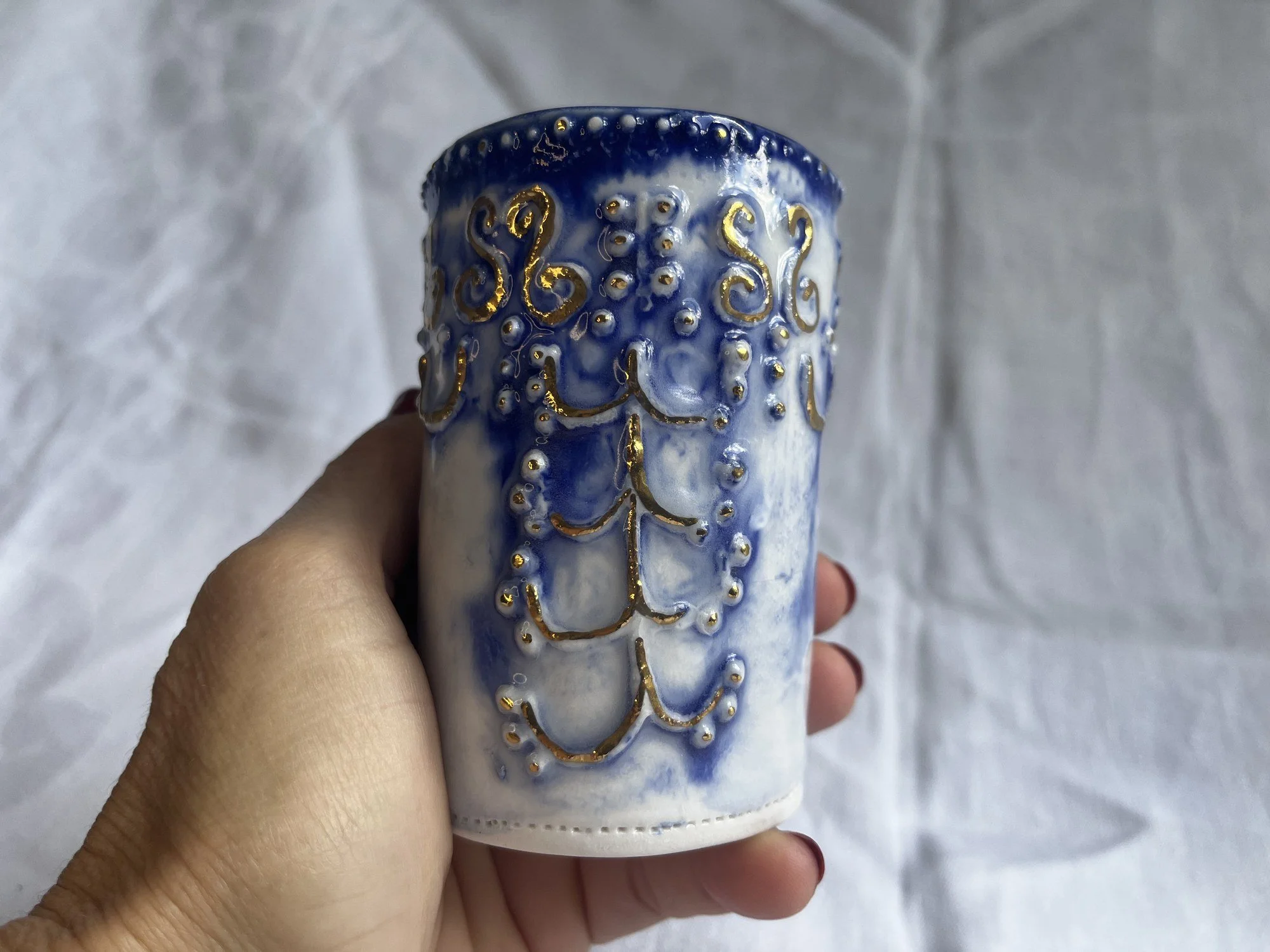 Small porcelain bud vase No. 003 held in hand to show its size