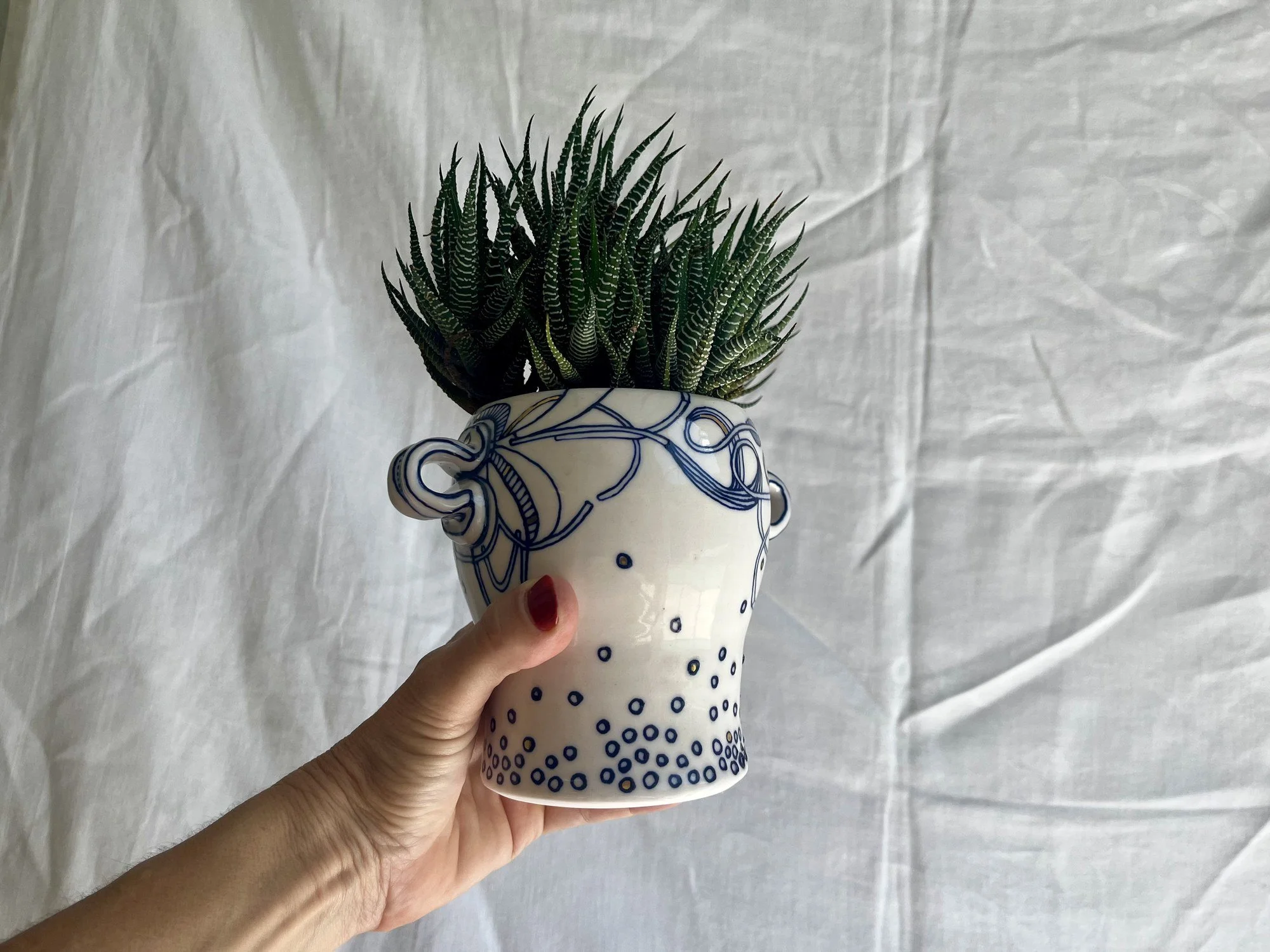 Small porcelain planter No. 001 held in hand to show its size