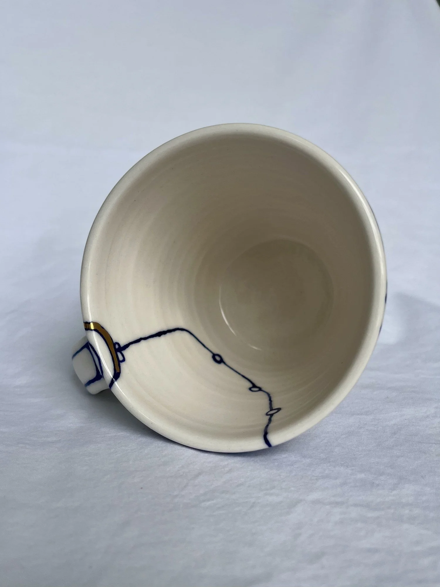 Further view of handmade porcelain mug No. 001 with cobalt blue and gold luster