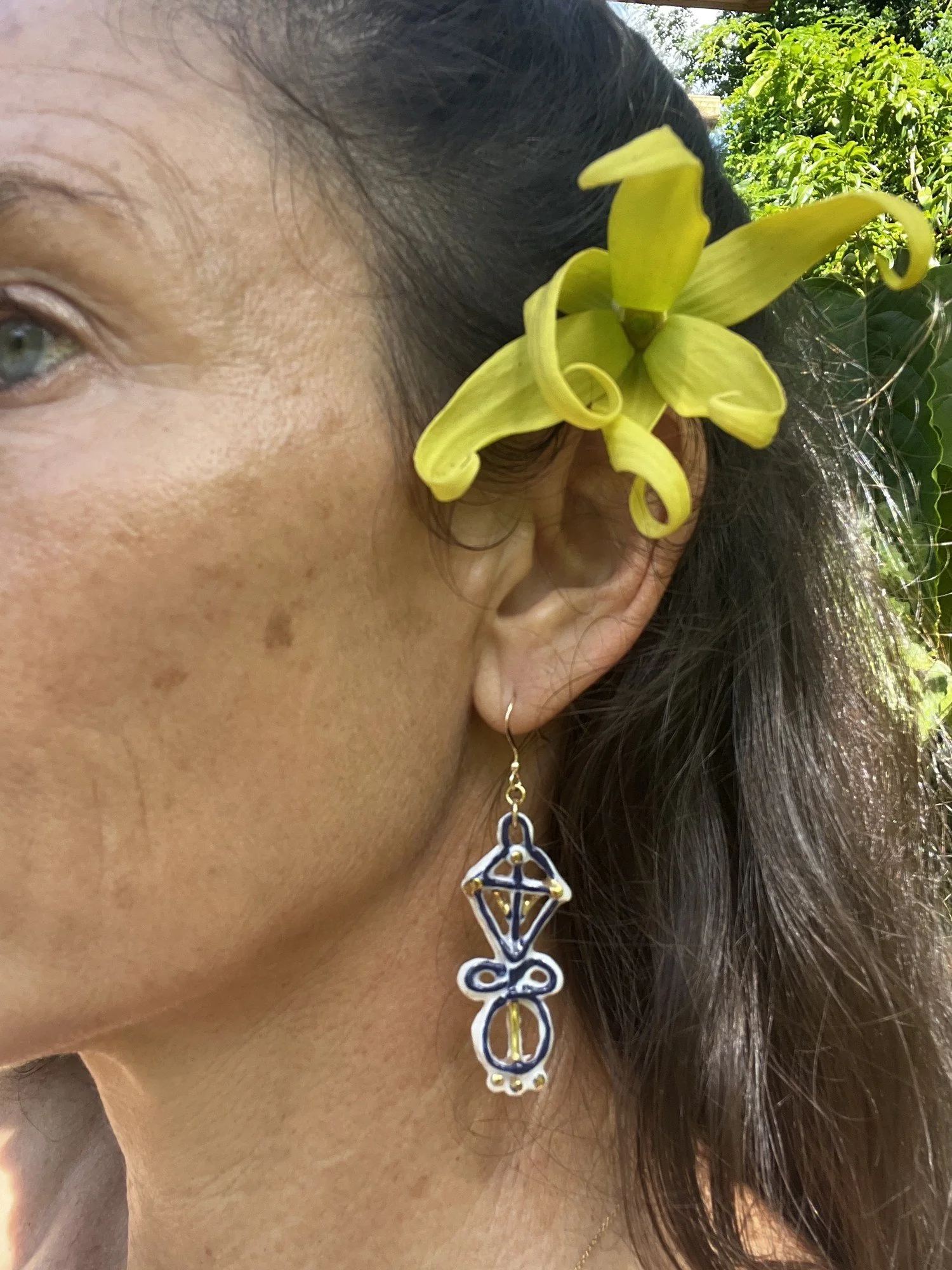 Porcelain earring No. 005 in cobalt blue and gold luster worn on the ear