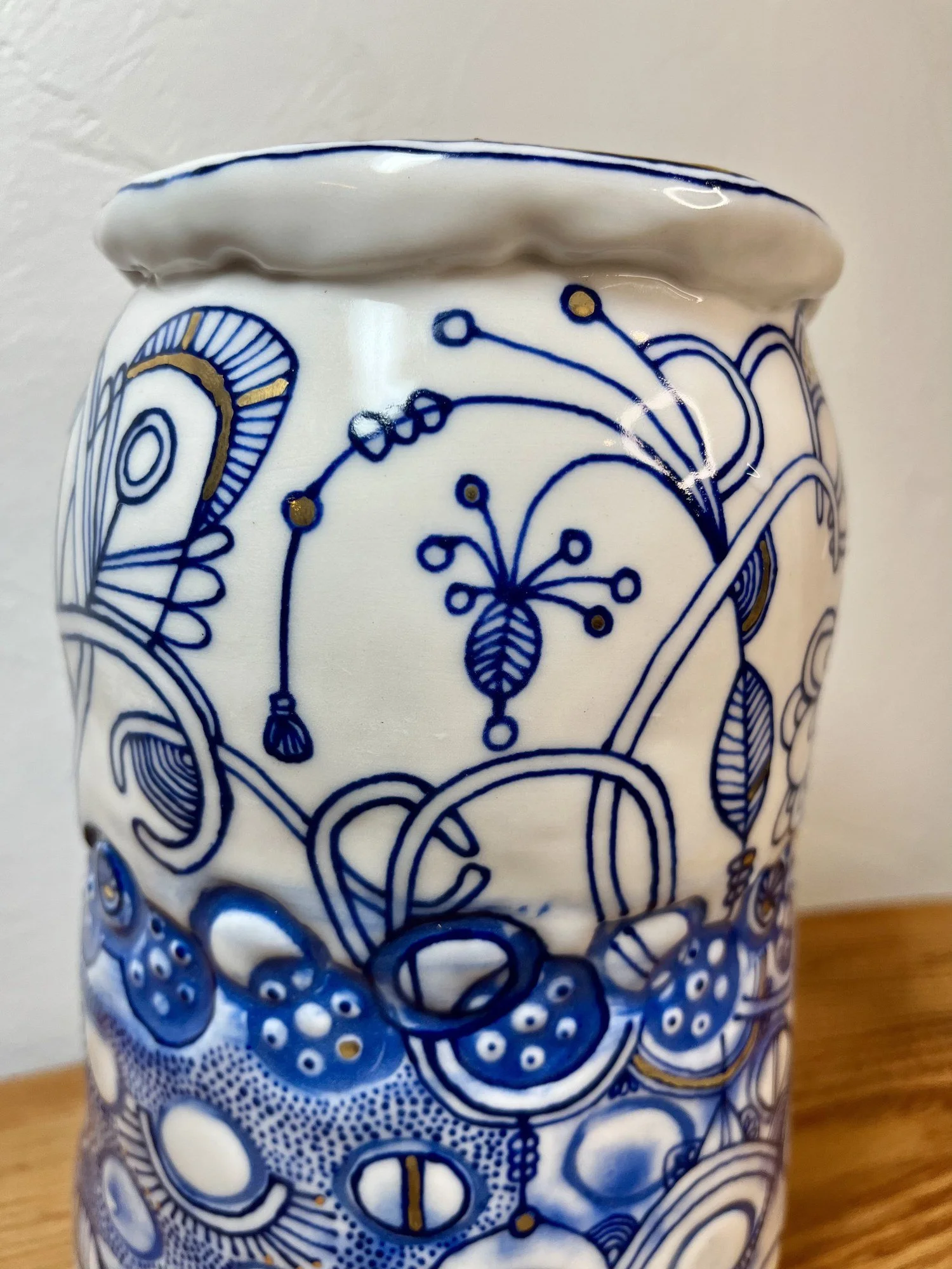 Ruffled rim and cobalt line work detail on handmade porcelain vase No. 001
