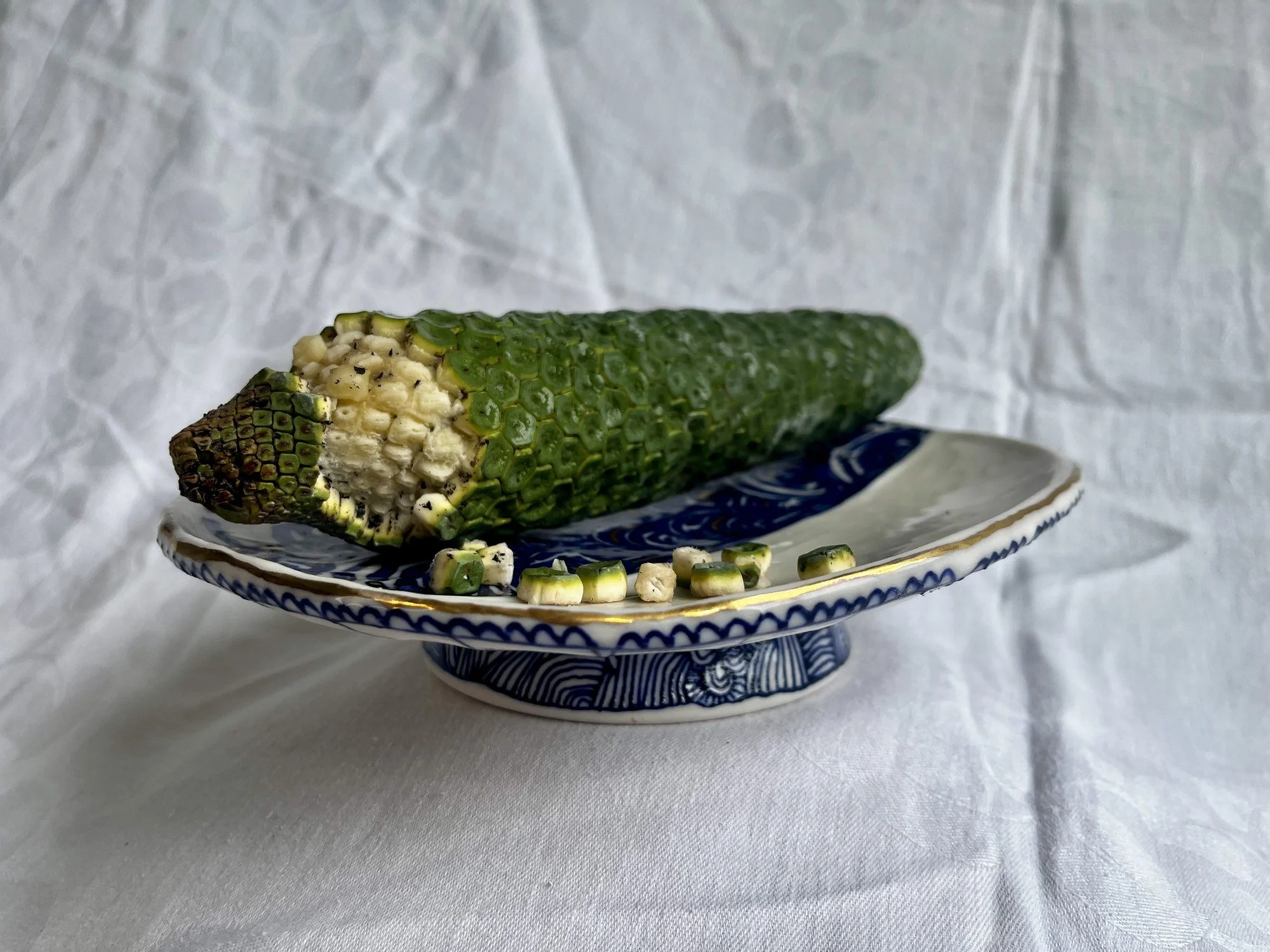Hand-thrown porcelain serving dish No. 002 holding monstera deliciosa fruit