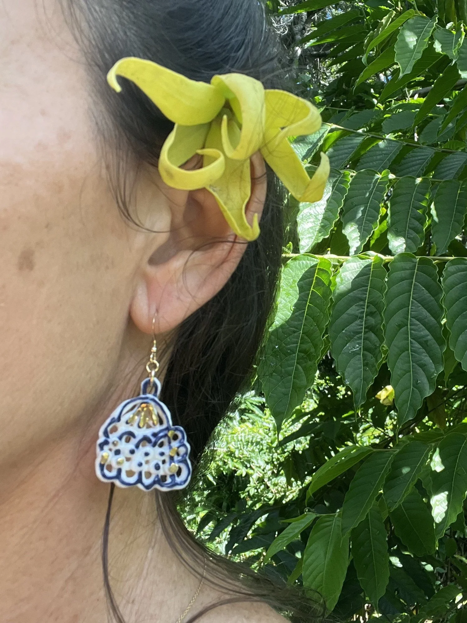 Porcelain earring No. 003 in cobalt blue and gold luster worn on the ear