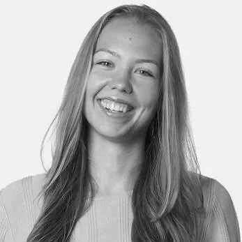 Black and white photo of a smiling woman with long blonde hair