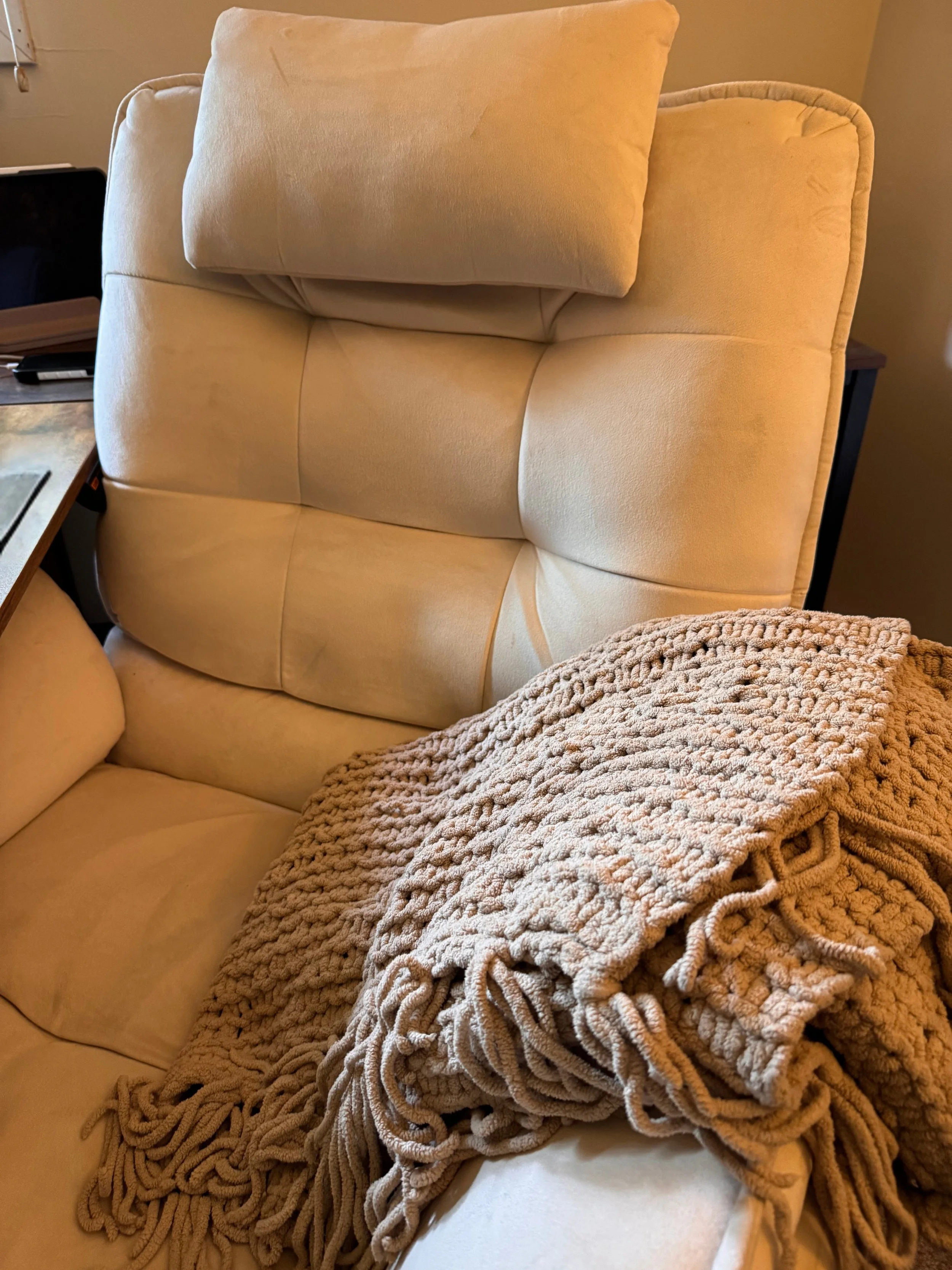 Recliner with a knit throw blanket, in a therapy space