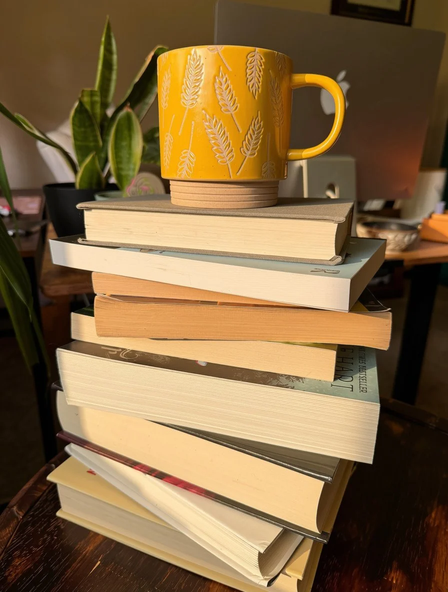 Patterned yellow mug on top of a stack of books