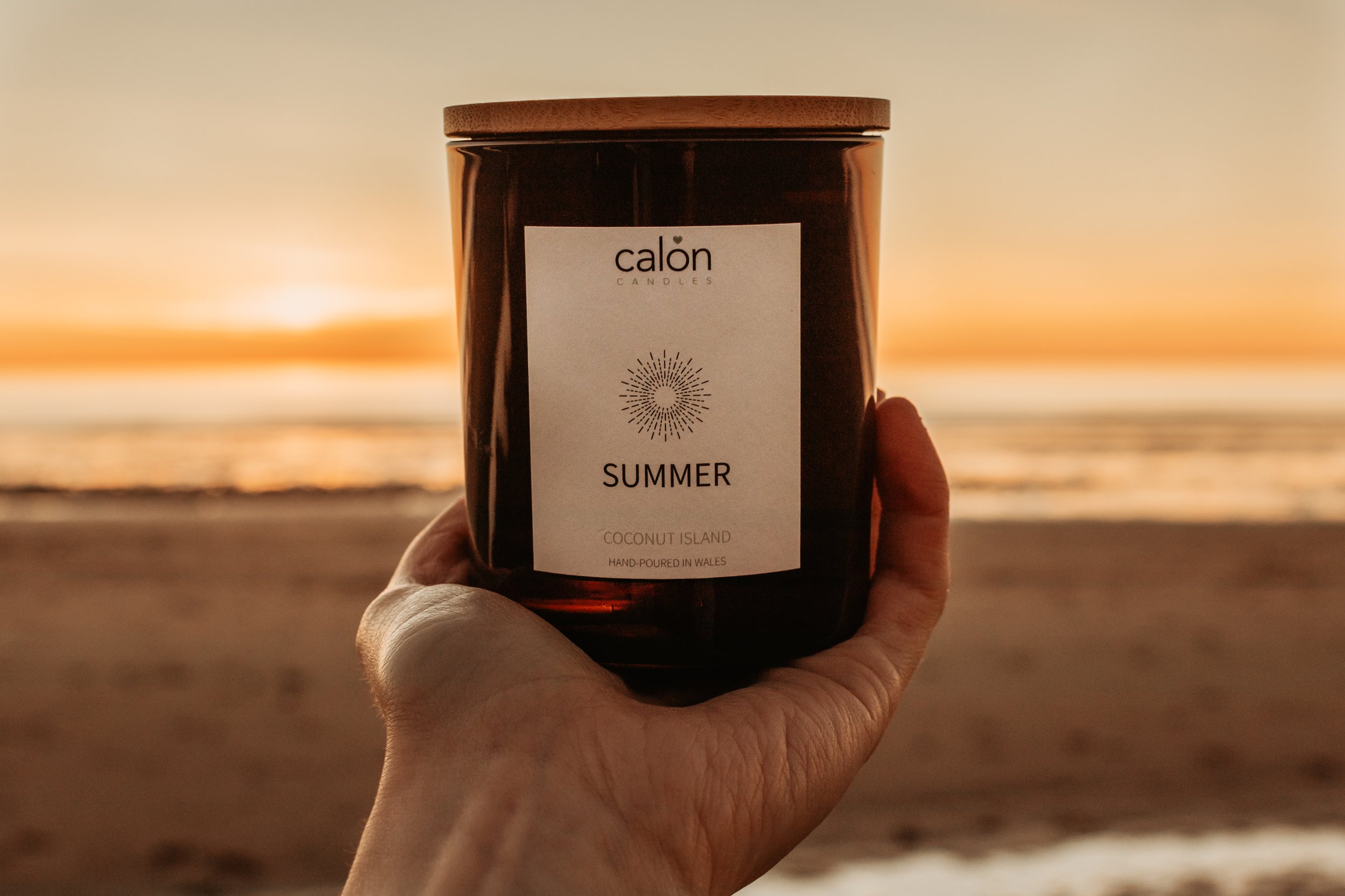 Coconut Island summer candle with lid - held in hand.jpg