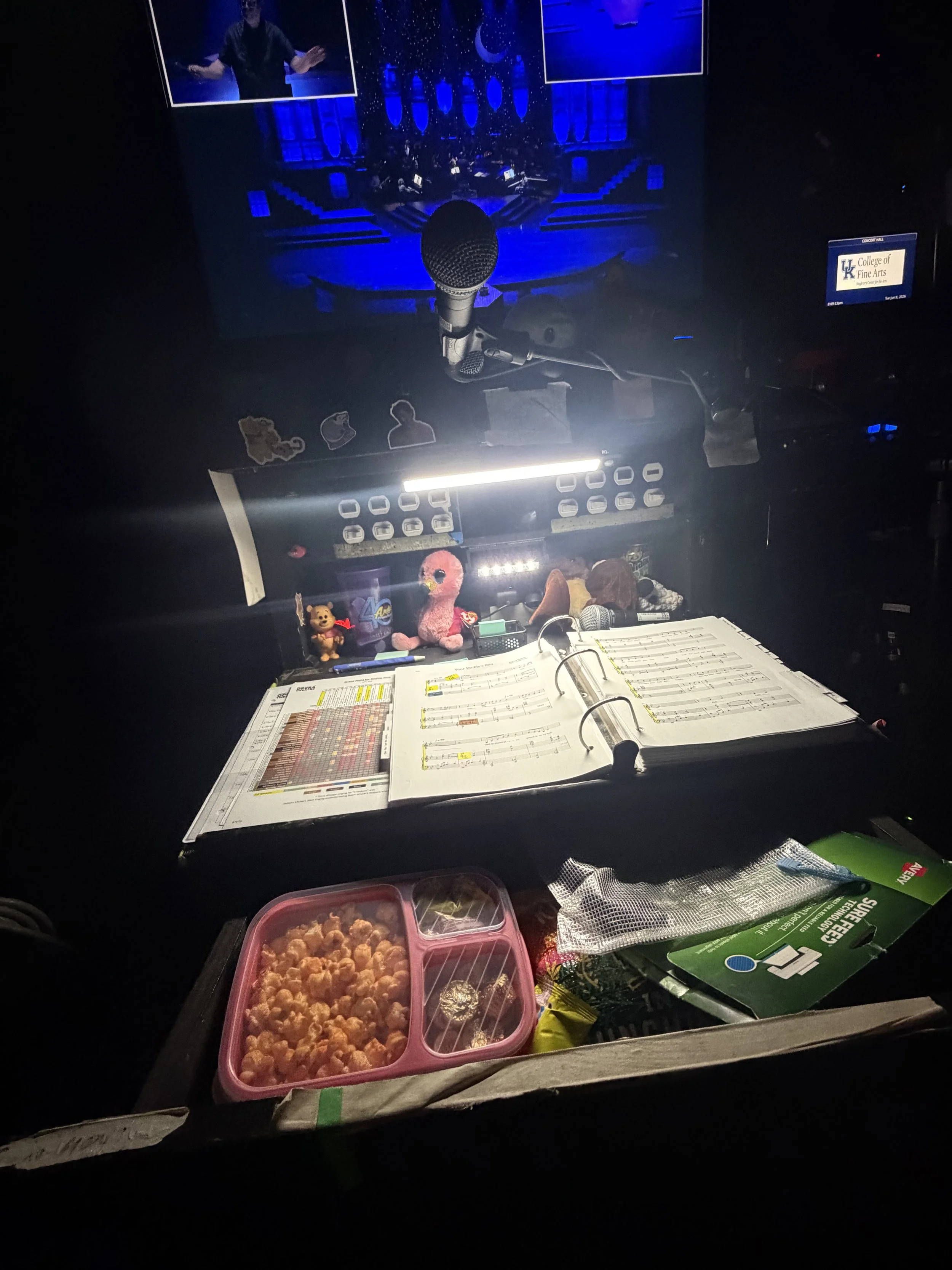 Stage management console, prepared with prompt book, snacks, and conductor monitor.