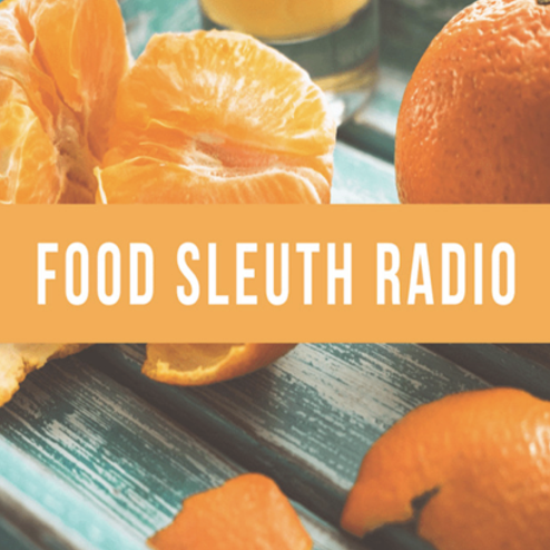 Close-up of sliced and whole oranges on a weathered blue wooden surface with a 
