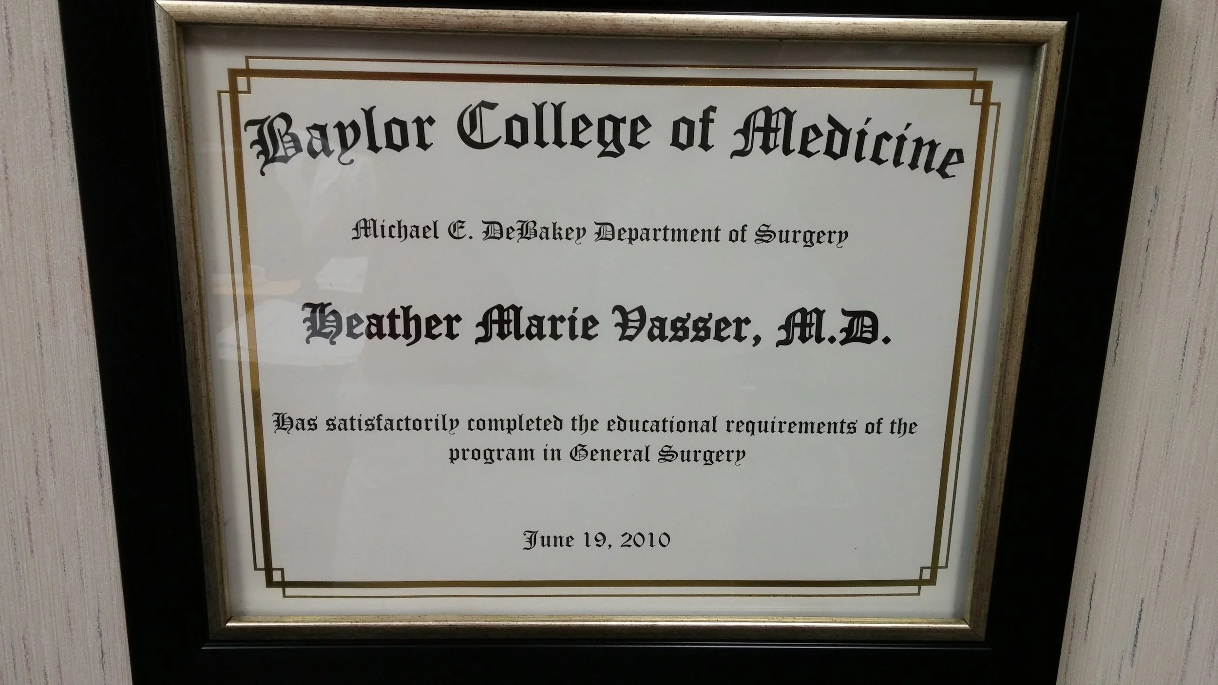Framed certificate from Baylor College of Medicine awarded to Heather Marie Wasser, M.D., dated June 19, 2010, indicating completion of the surgical program.