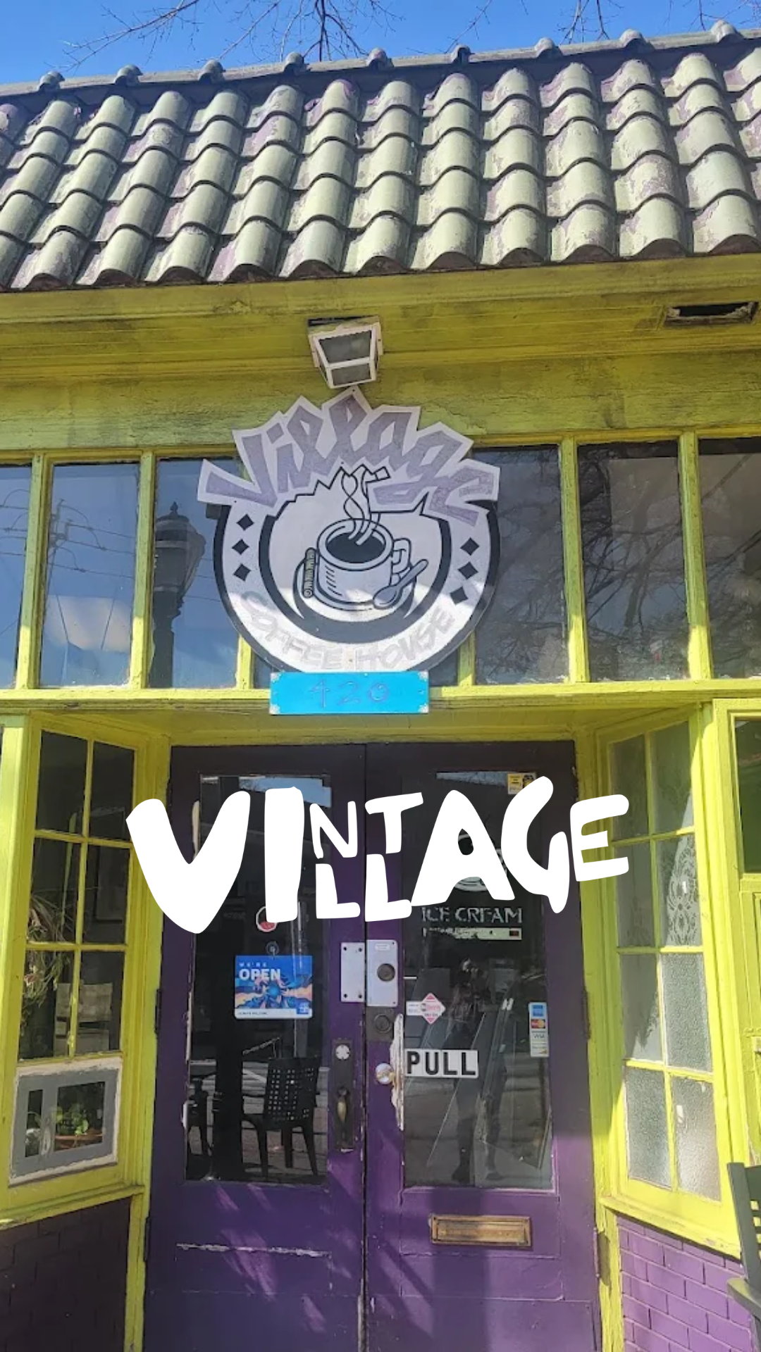 VINTAGE coffee shop with yellow window frames and purple door, sign with a steaming coffee cup, palm trees, and clear blue sky