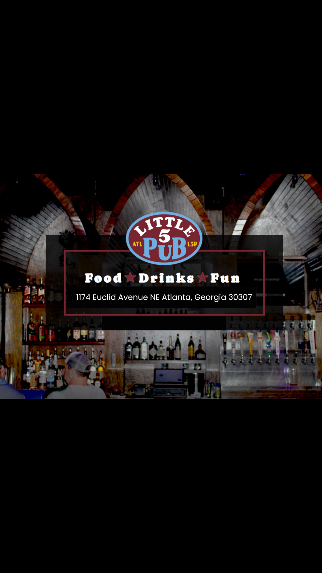 A bar with a sign for Little 5 Pub in Atlanta, Georgia, featuring a wooden bar with bottles of liquor and taps for draft beers, and a person wearing a cap at the bar.