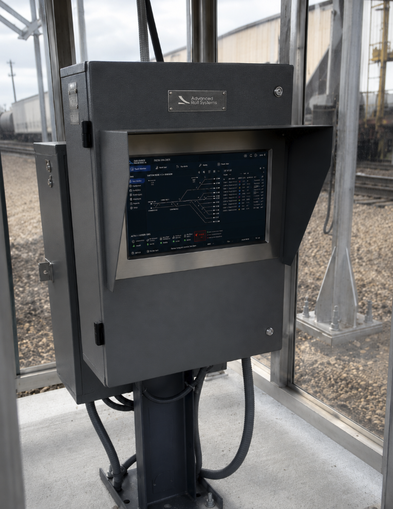 Railway signal control system with a touchscreen interface at a train station.