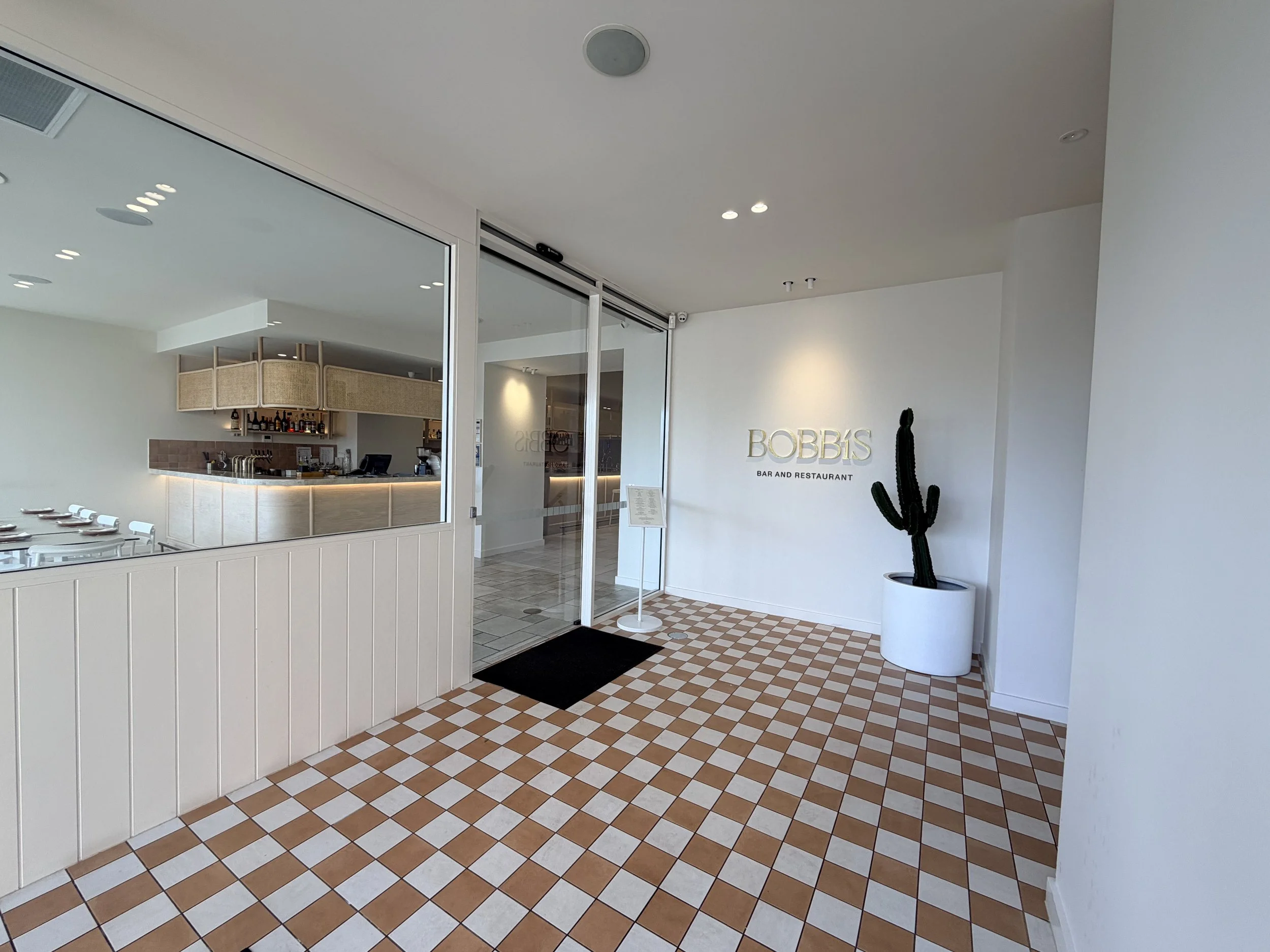 Commercial fit-out by ACAT Build at Bobbi's Bar & Restaurant, Hilton Hotel, featuring a custom restaurant entrance and premium finishes.