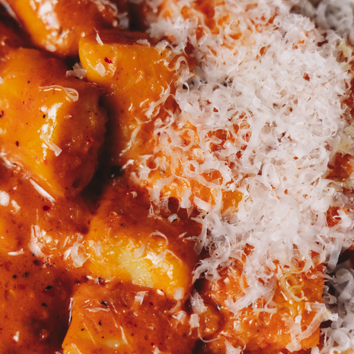 Close-up of cooked ravioli pasta with tomato sauce and grated cheese on top. Served at Vera Restaurant Glasgow Southside 138 Nithsdale Road.