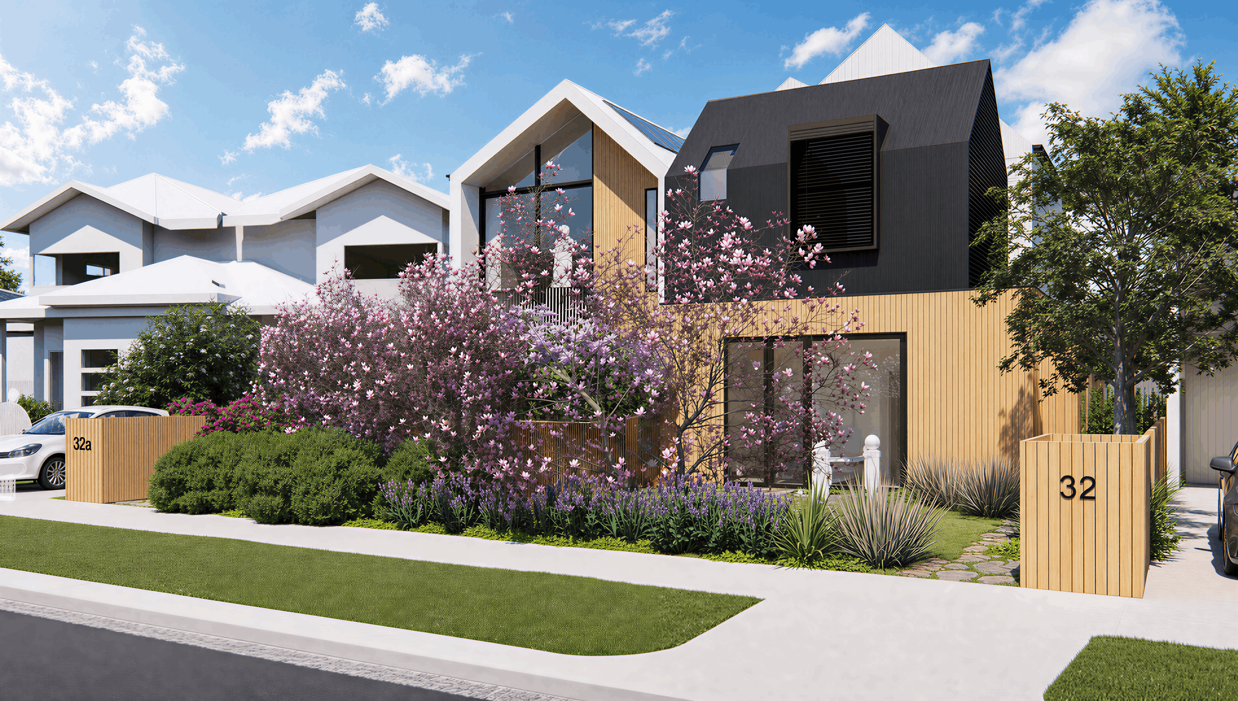 Modern multi-story house with white, black, and wooden exterior elements, surrounded by landscaped garden with blooming pink and purple flowers, and a tree under a blue sky with clouds.