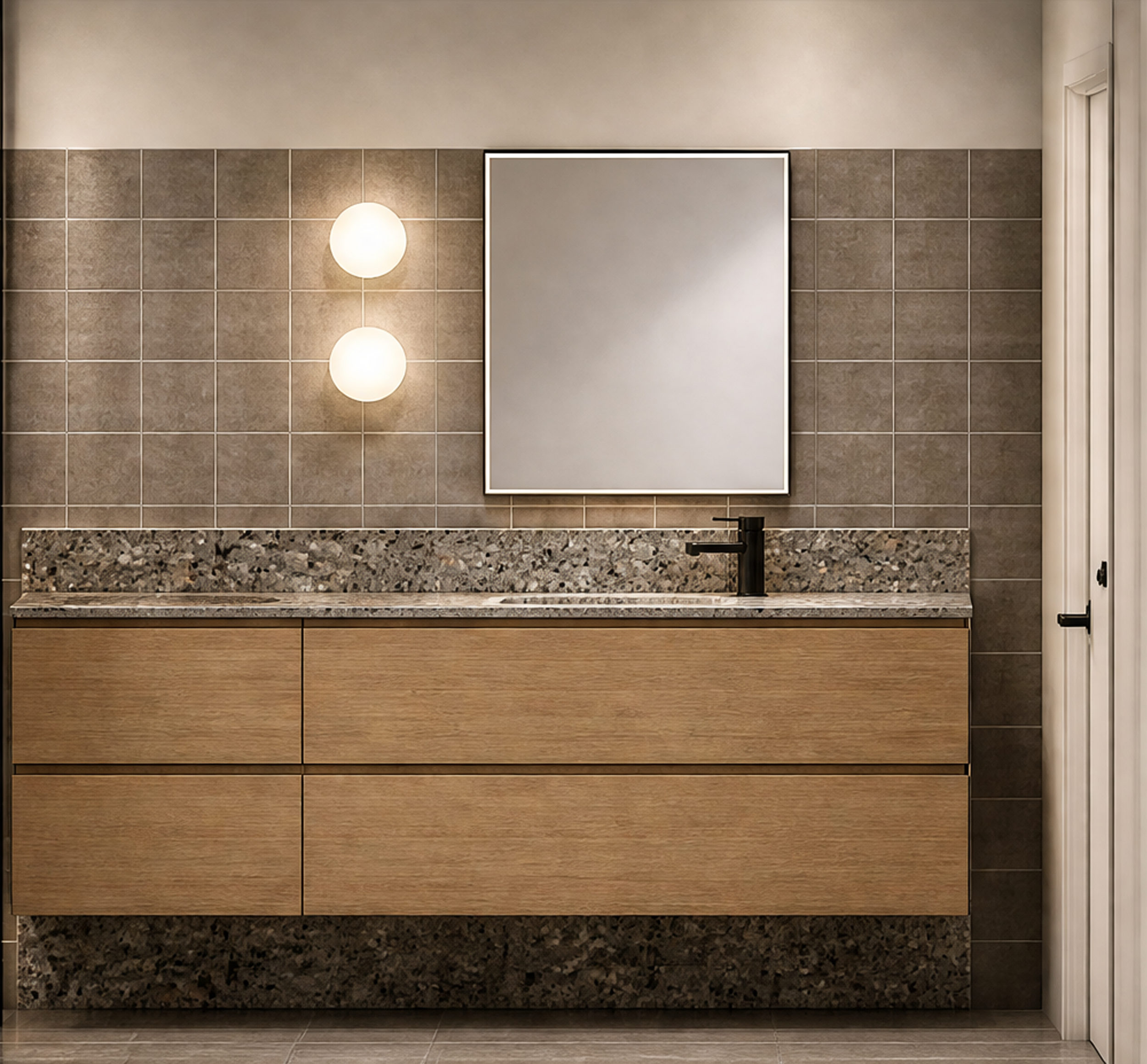 Bathroom vanity with brown wooden cabinets, beige granite countertop, large mirror, and beige tile wall with two round wall lights. Part of white door is visible on the right.