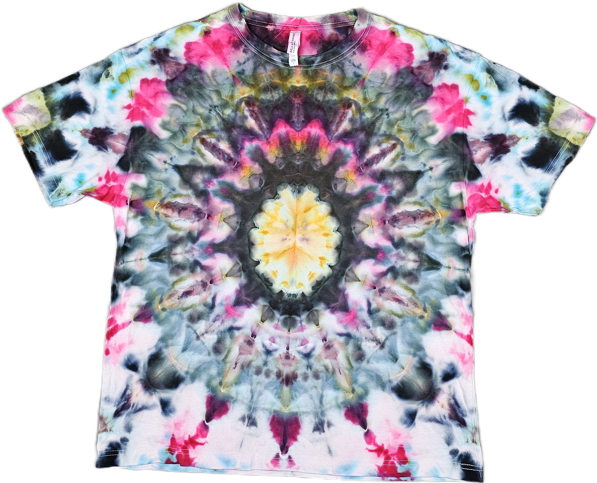 Bella + Canvas Colorful tie-dye T-shirt with pink, black, yellow, blue, and white patterns, laid flat on a surface.