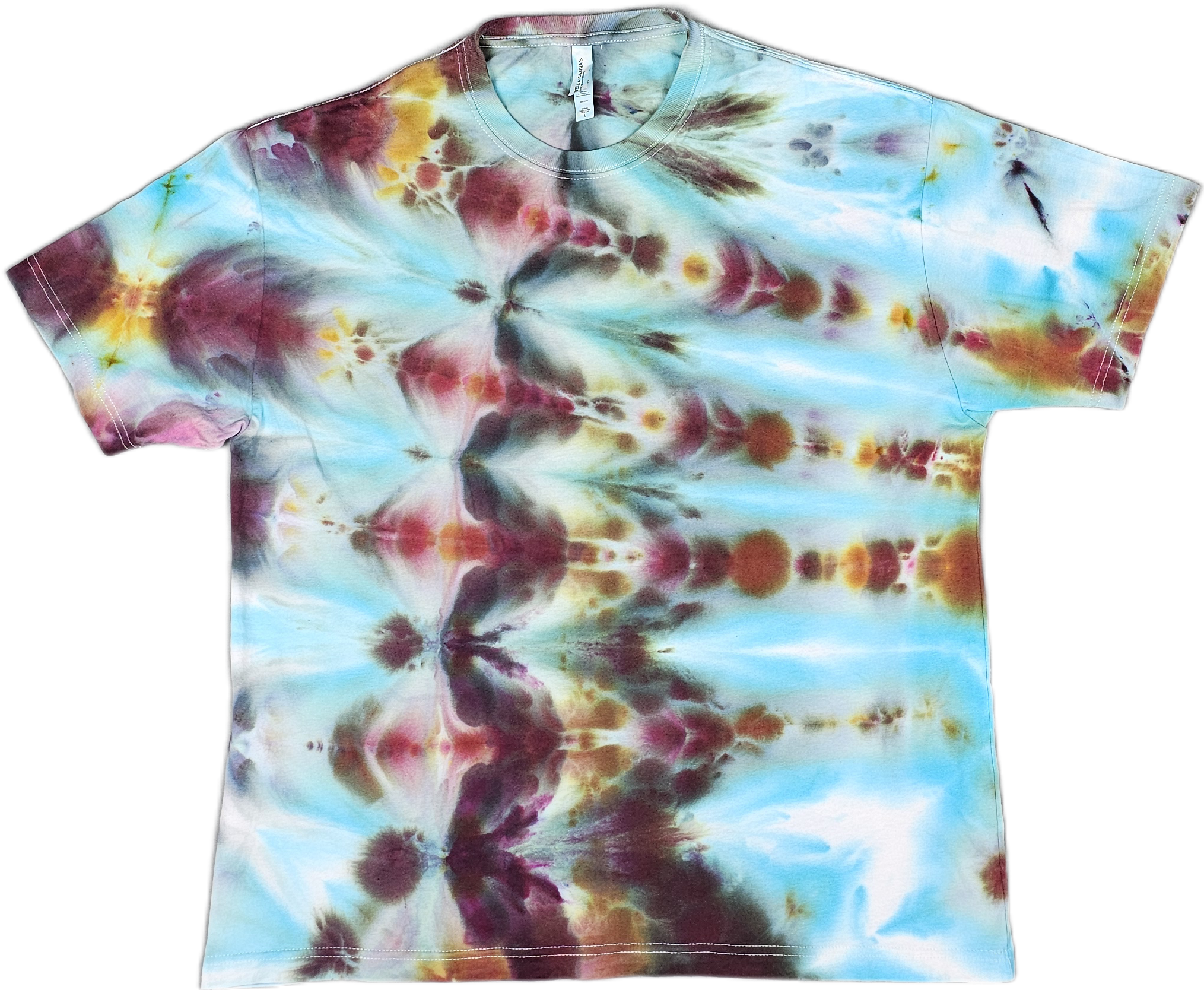 A Bella + Canvas  tie-dye T-shirt with a colorful pattern in shades of blue, yellow, red, and black.