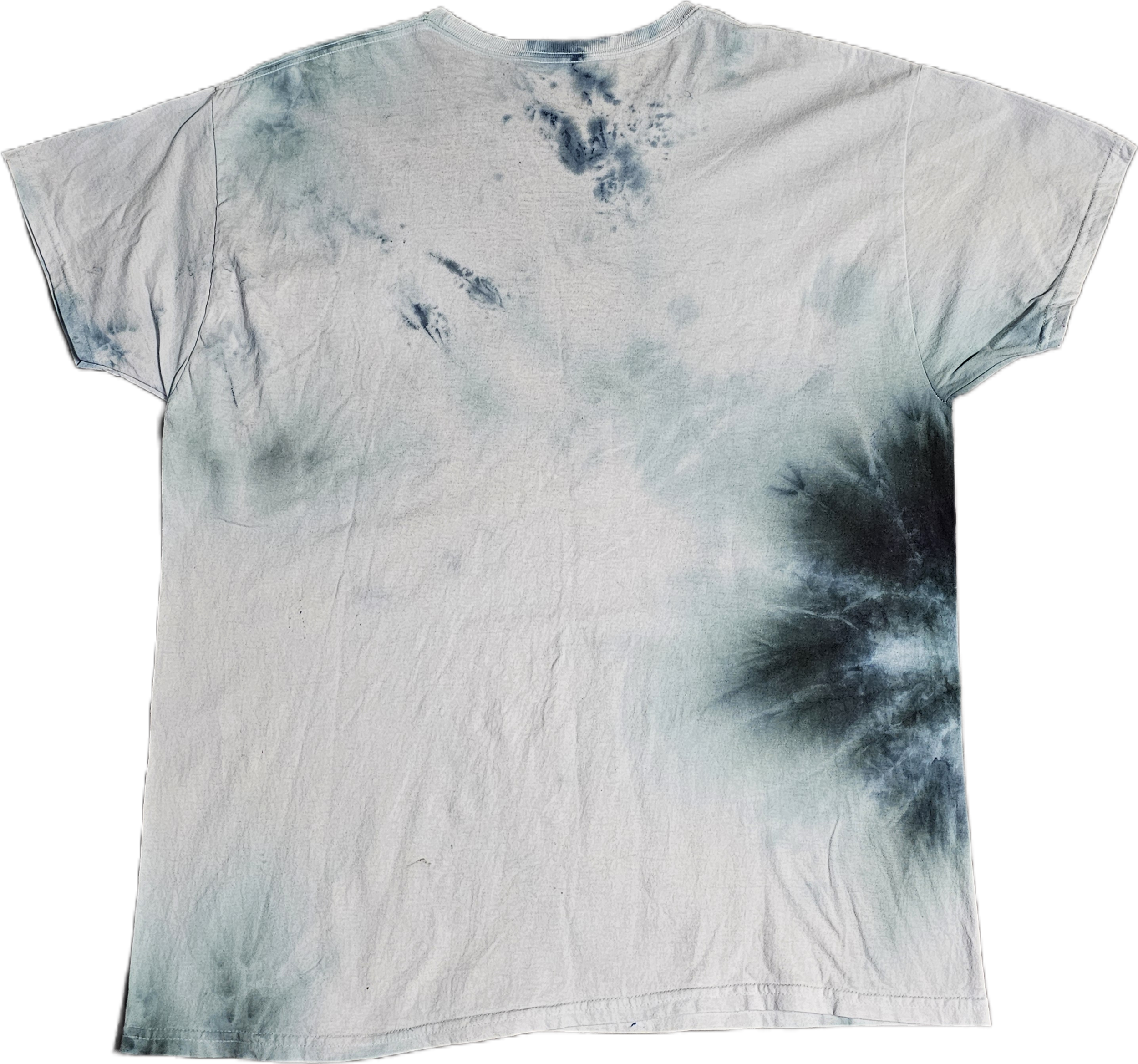 A Hanes light-colored tie-dye T-shirt with darker blue and green patches, wrinkled, with visible creases and a faded appearance.