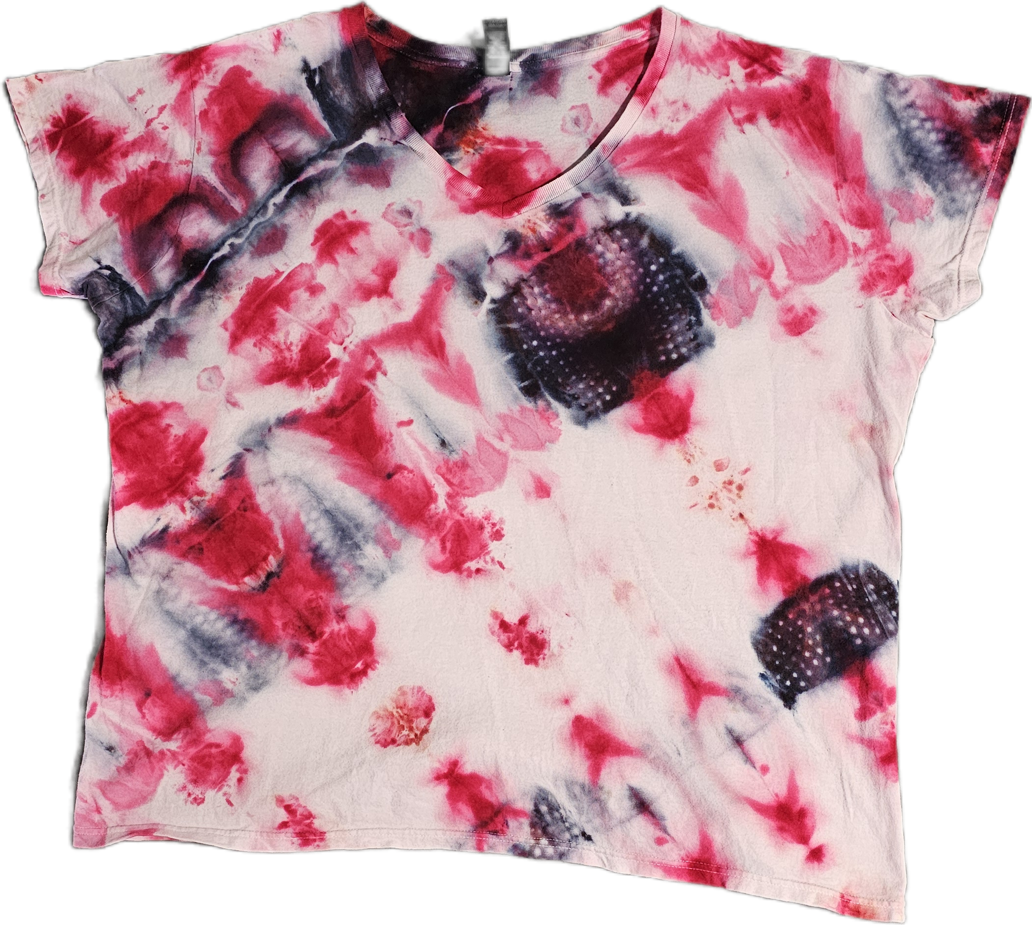 A colorful tie-dye T-shirt with pink, black, and white patterns and a round neckline.