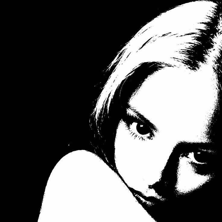 Black and white high-contrast photo of a young woman with short hair, looking at the camera.