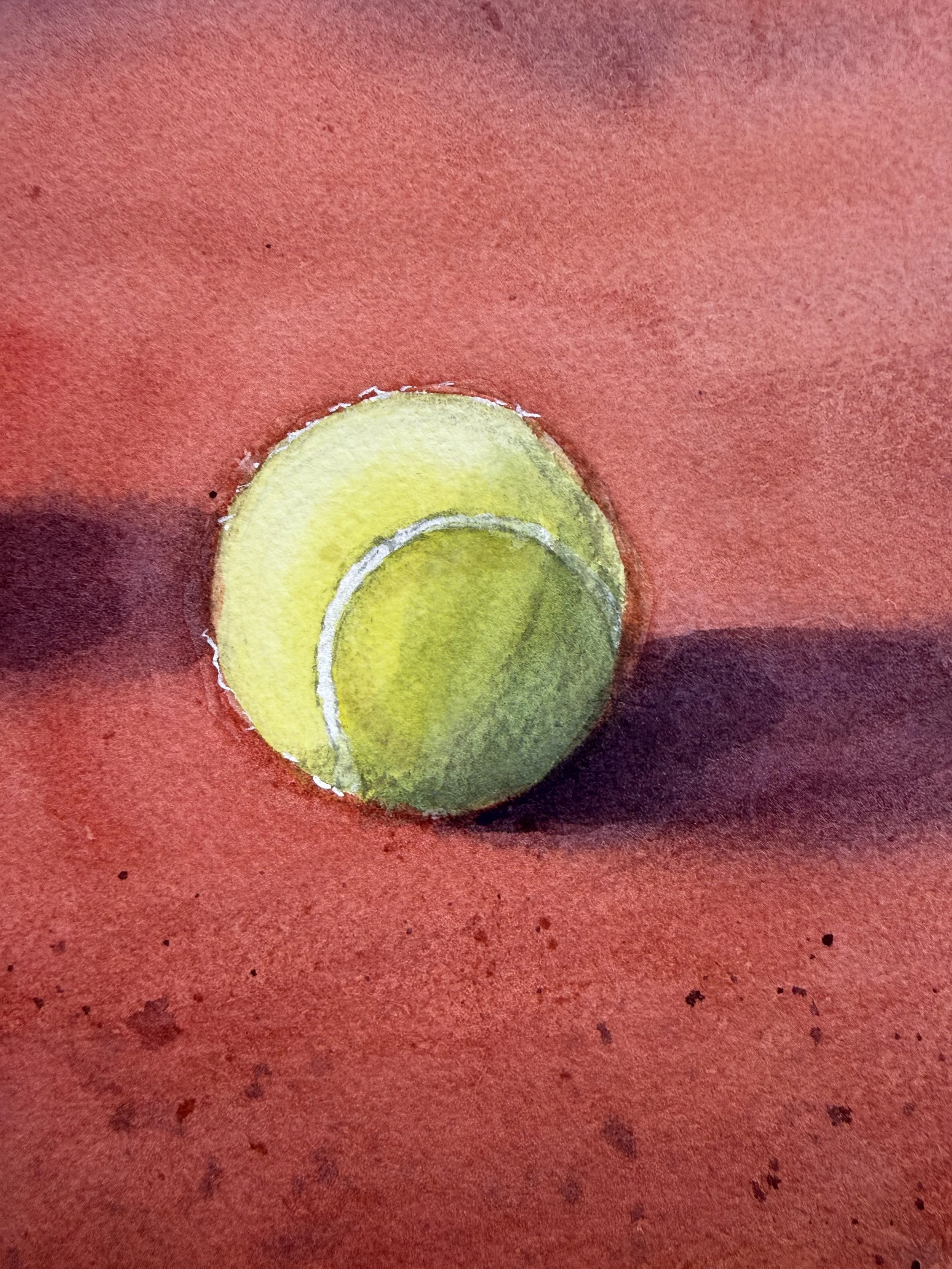 Detail of a tennis ball on clay court in HLTC Clubhouse under Blue Sky
