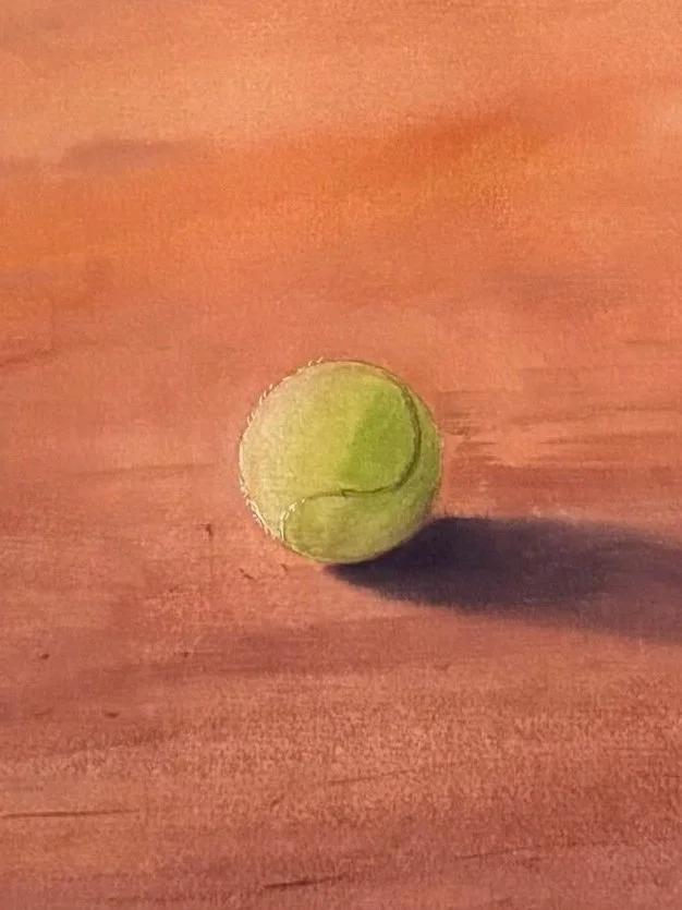 Close-up detail of a tennis ball on a clay court in Before the Serve